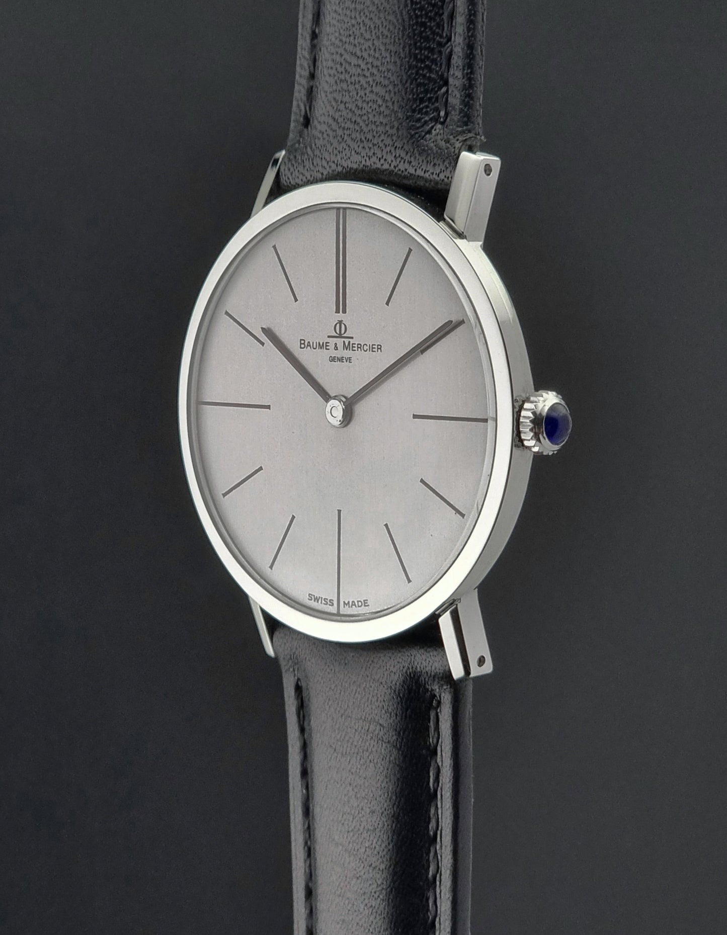 Baume et Mercier Wristwatch with black strap and silver case on a dark background