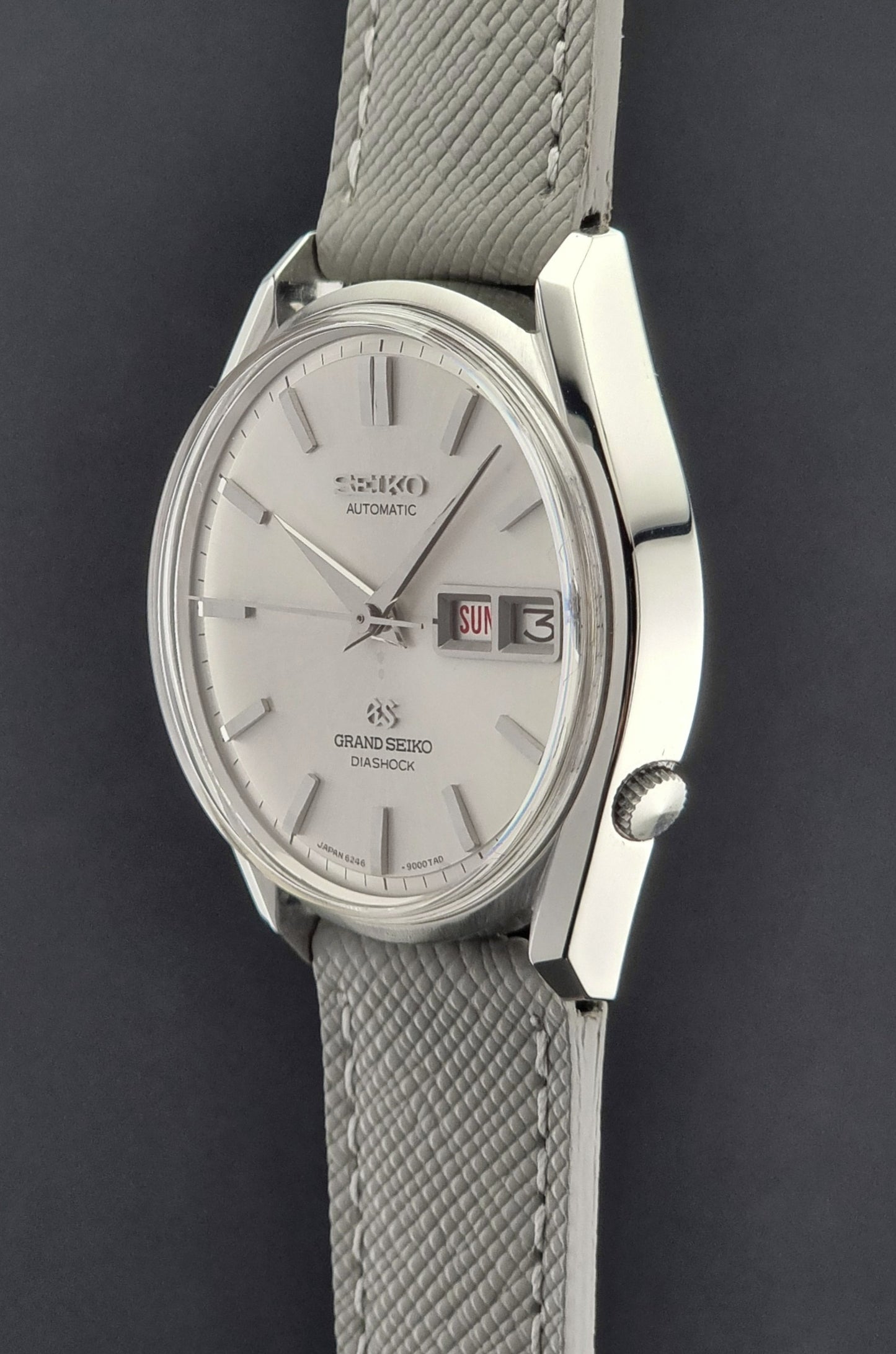 Vintage Grand Seiko watch with gray strap on a dark background