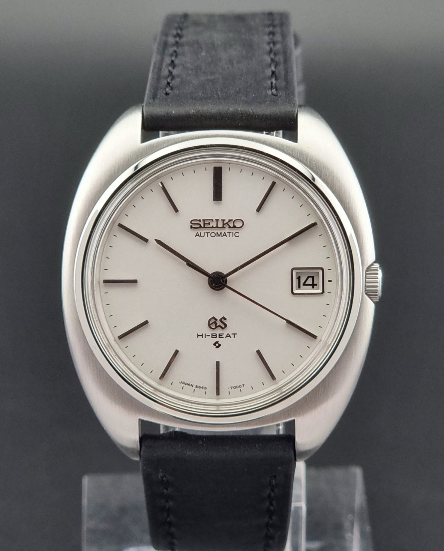 Grand Seiko watch with black leather strap on a dark background