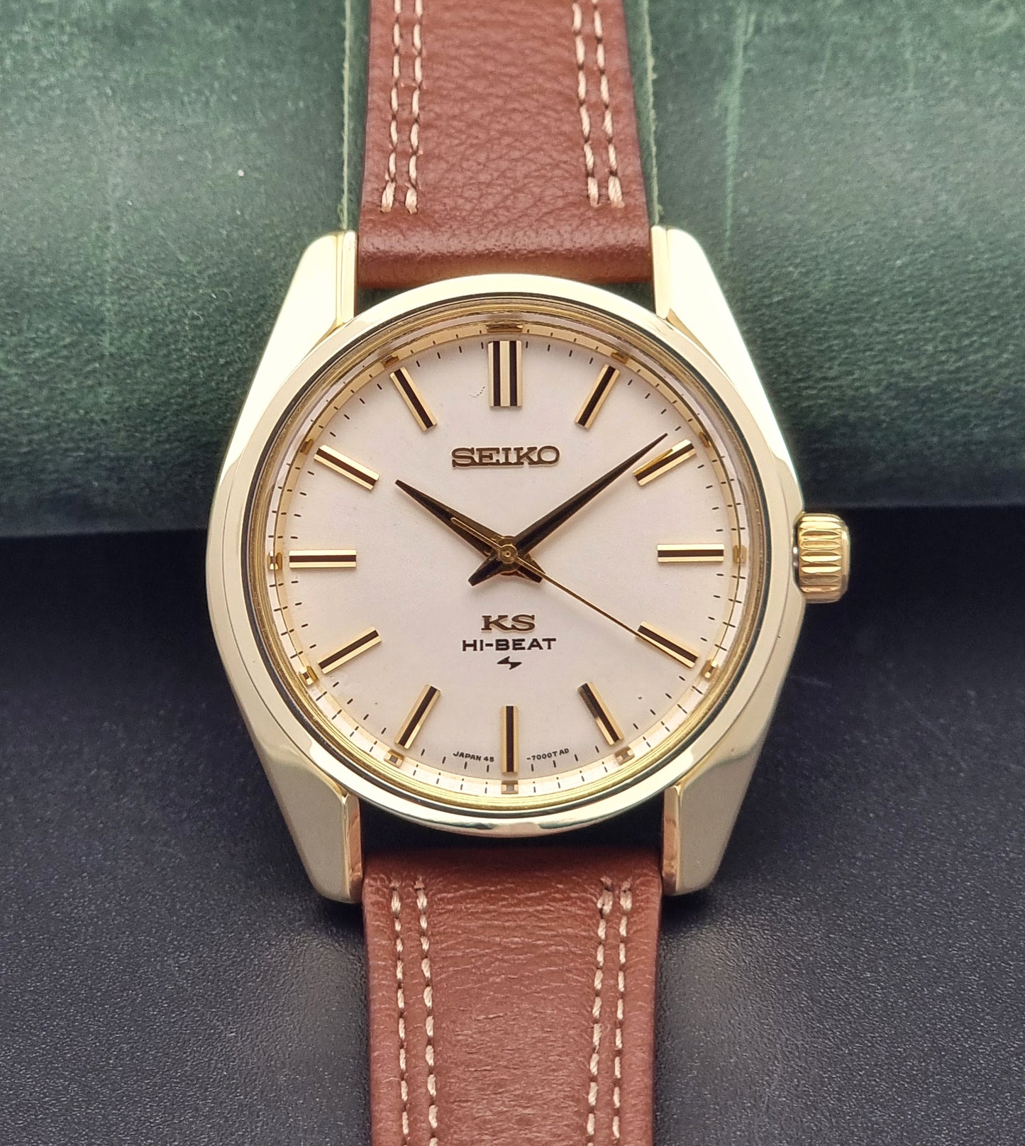 Vintage King Seiko watch with brown leather strap on a dark surface