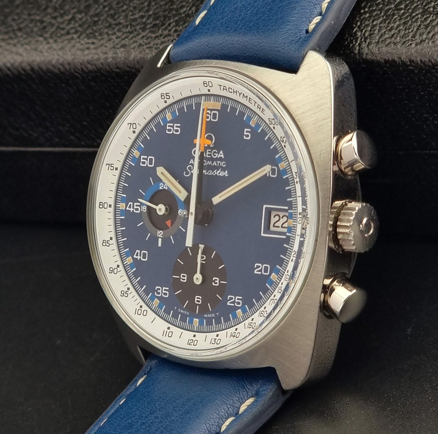 Vintage Omega Seamaster watch with blue strap and blue dial on a dark background