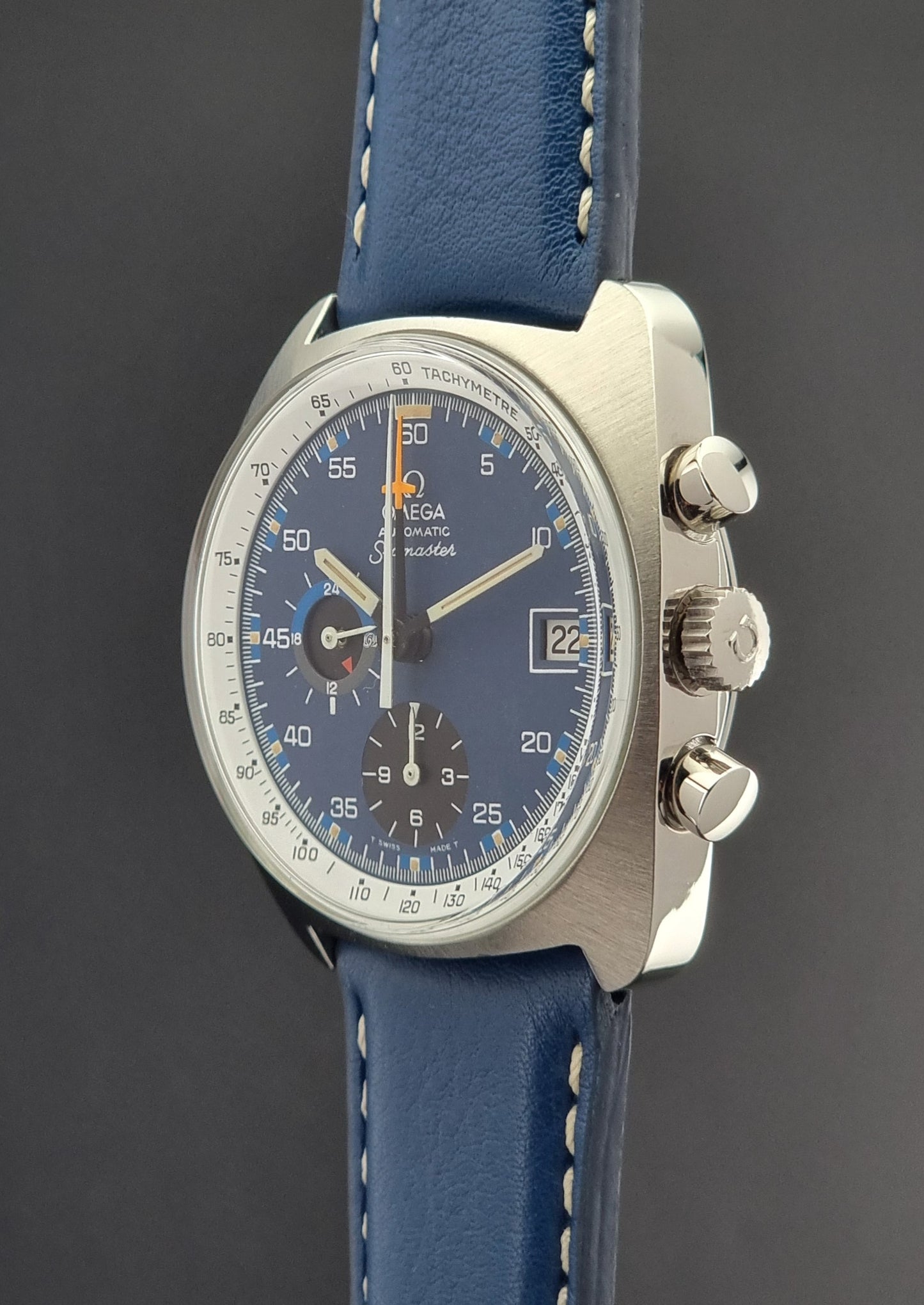 Vintage Omega Seamaster watch with blue strap and blue dial on a dark background
