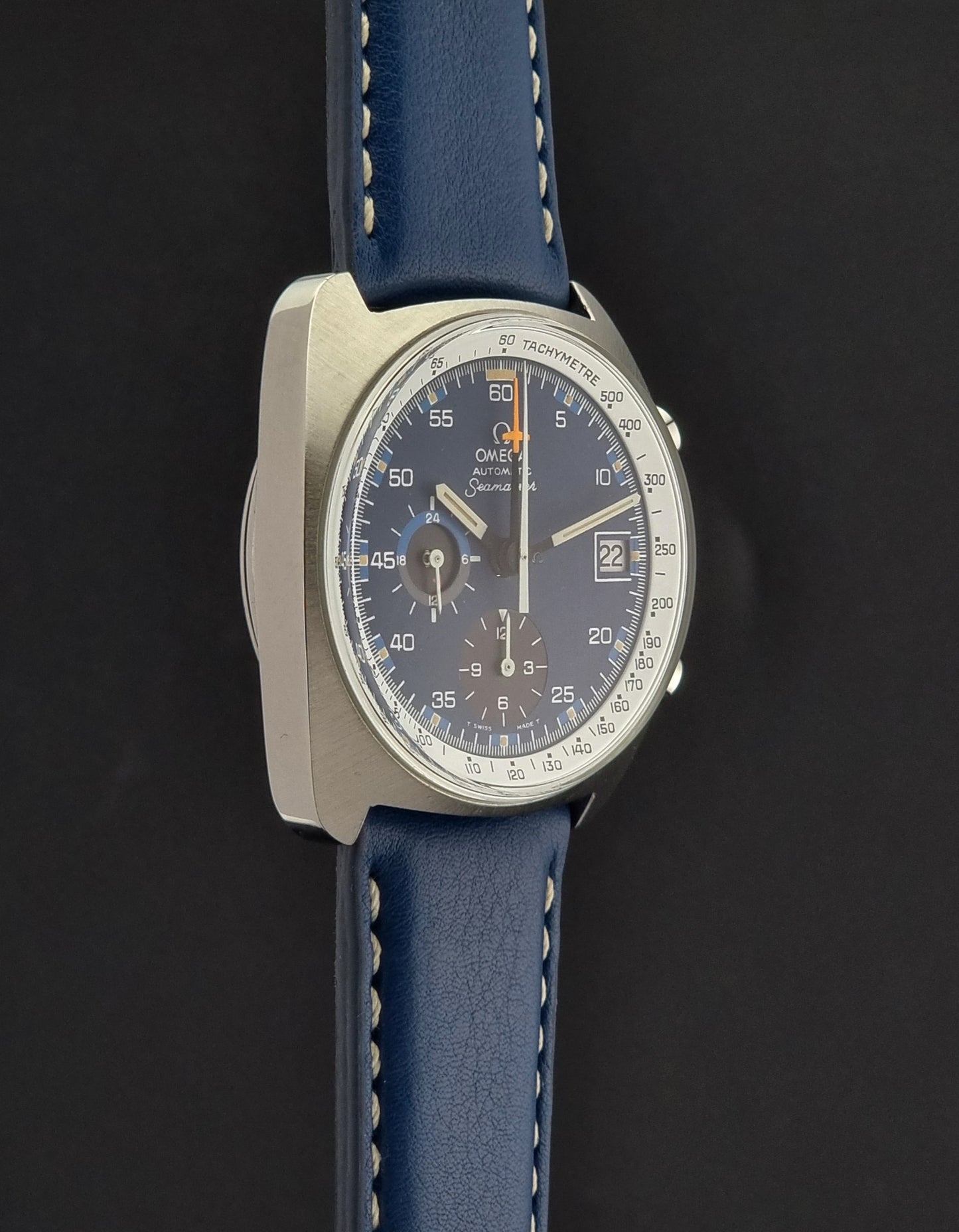 Vintage Omega Seamaster Wristwatch with blue strap and detailed face on a dark background