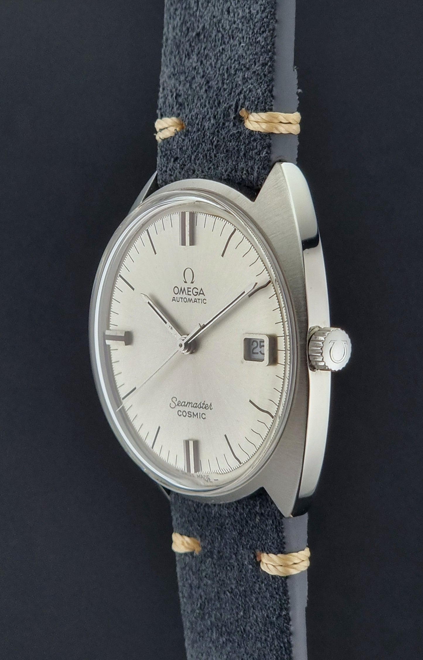 Vintage Omega watch with blue strap on a dark background