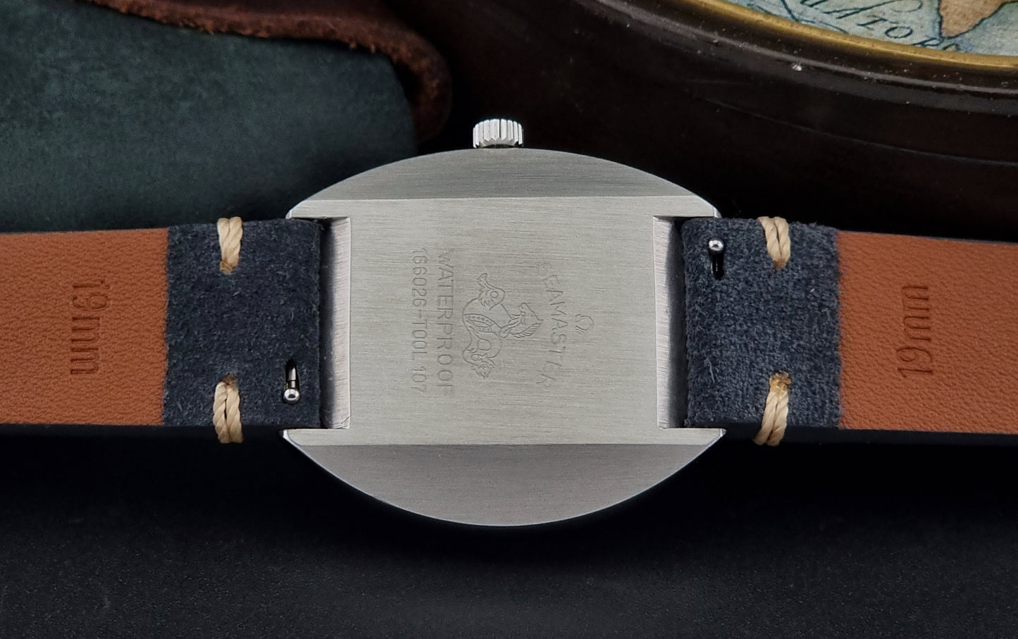 Close-up of the case of a Vintage Omega Seamaster with a detailed strap on a dark background
