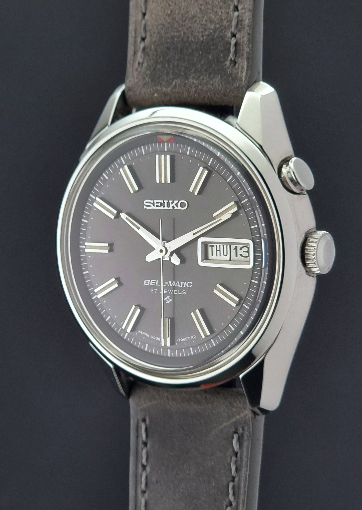 Seiko Bell-Matic watch with gray leather strap on a dark surface