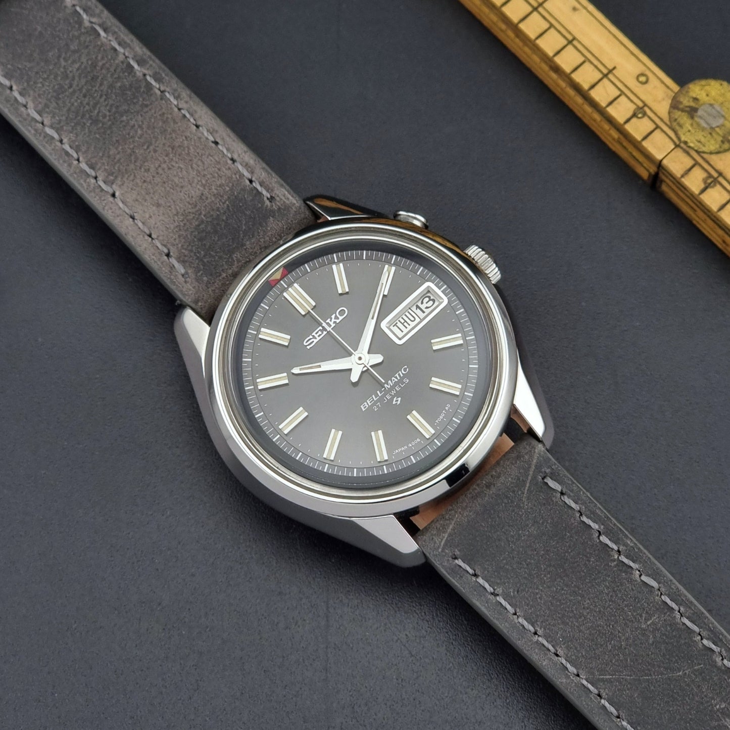 Seiko Bell-Matic watch with gray leather strap on a dark surface