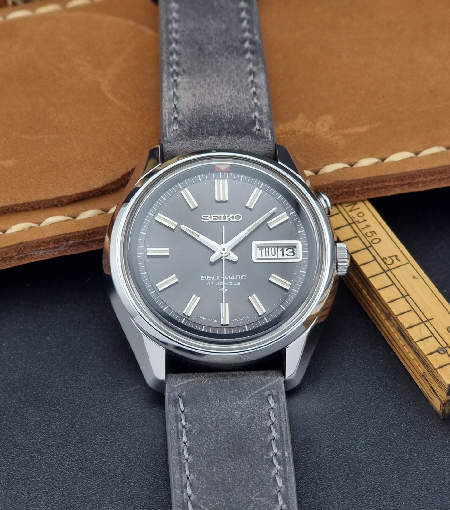 Seiko Bell-Matic watch with gray leather strap on a dark surface