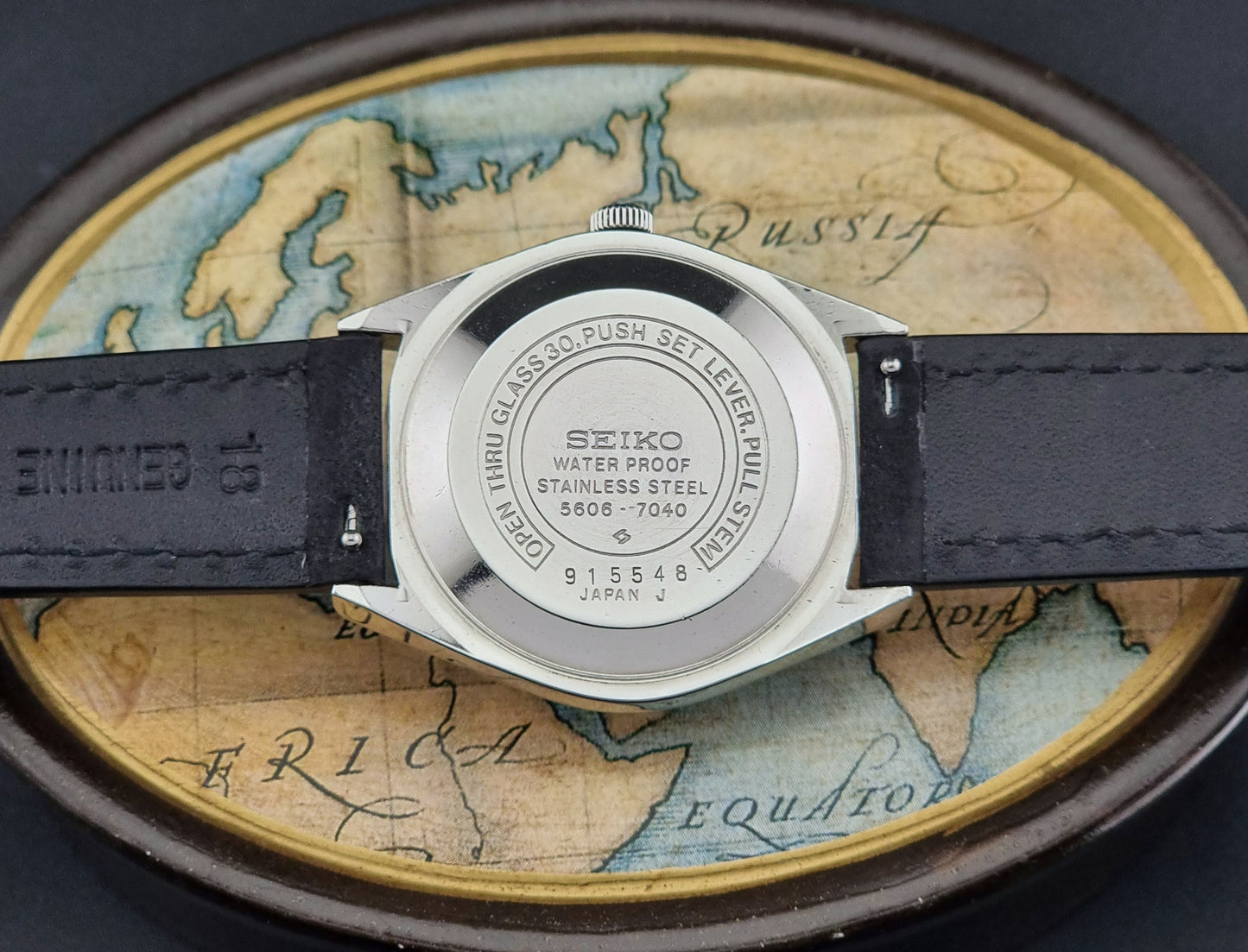 Seiko watch back on a world map background