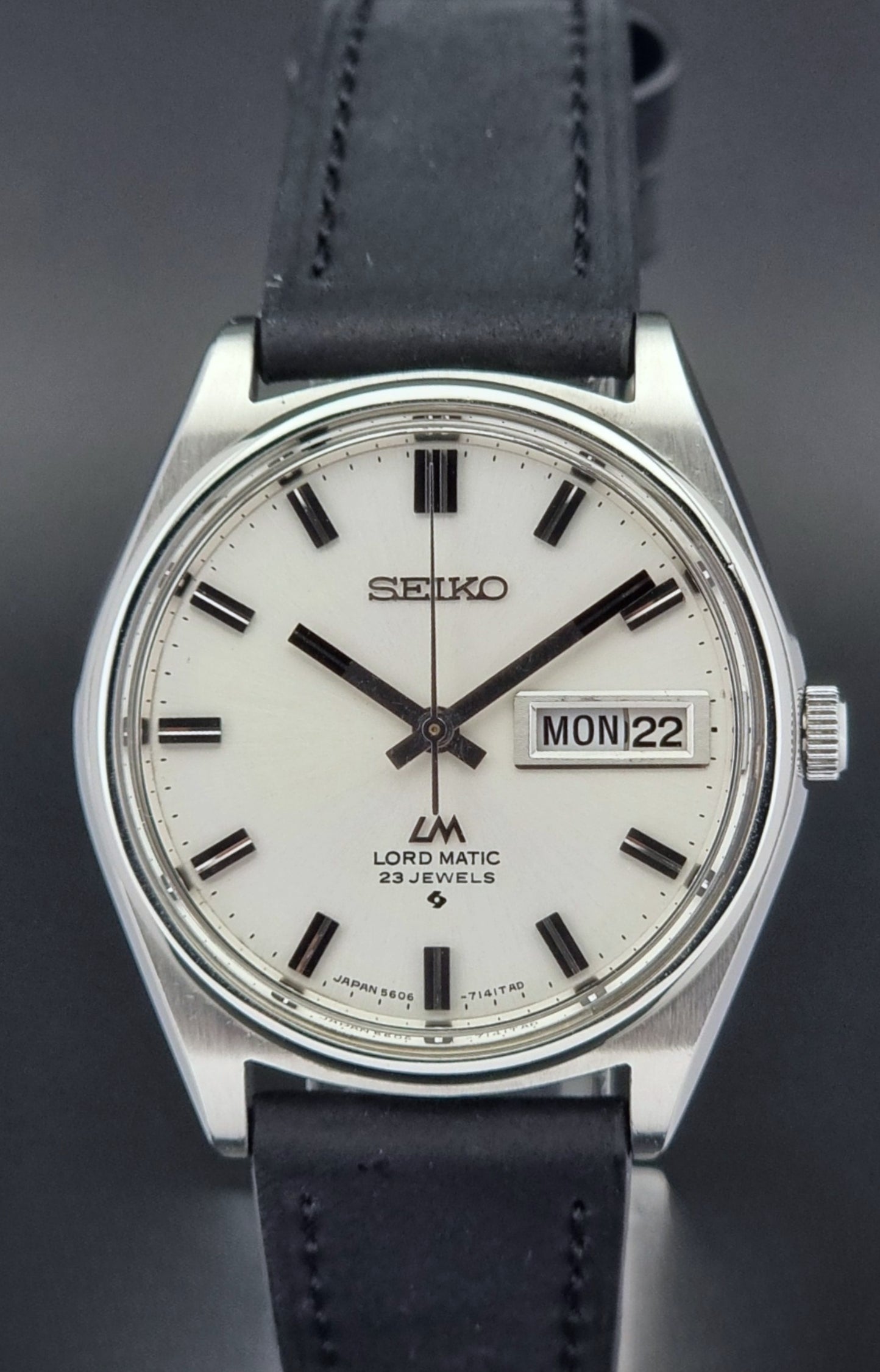 Vintage Seiko Lord Matic watch with black leather strap on a dark background