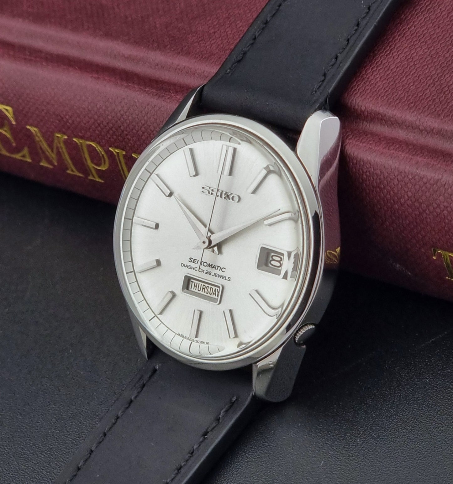 Seiko Seikomatic 6206-8040 Wristwatch with black strap on a dark surface