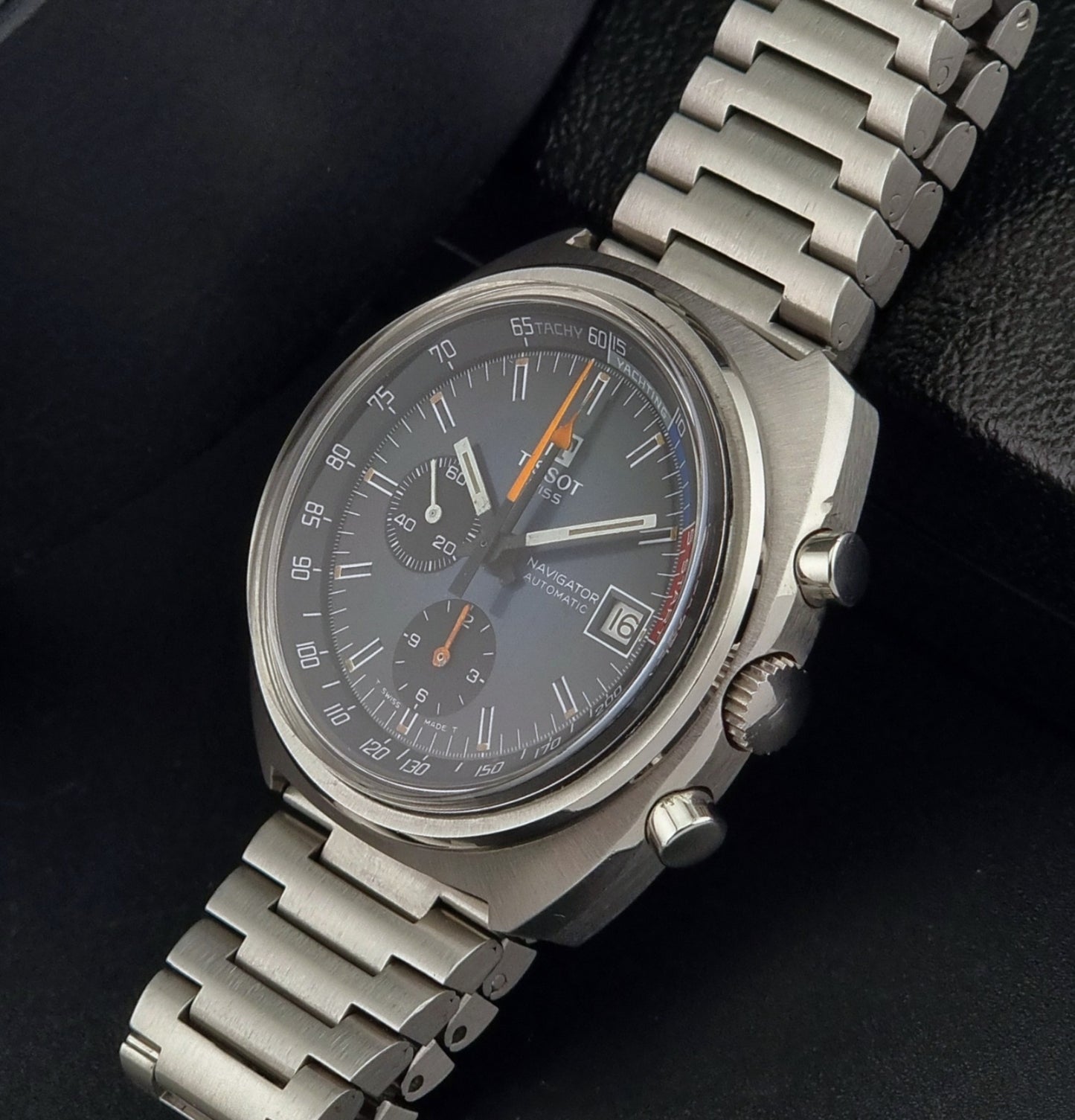 Vintage Tissot wristwatch with detailed face on a dark background