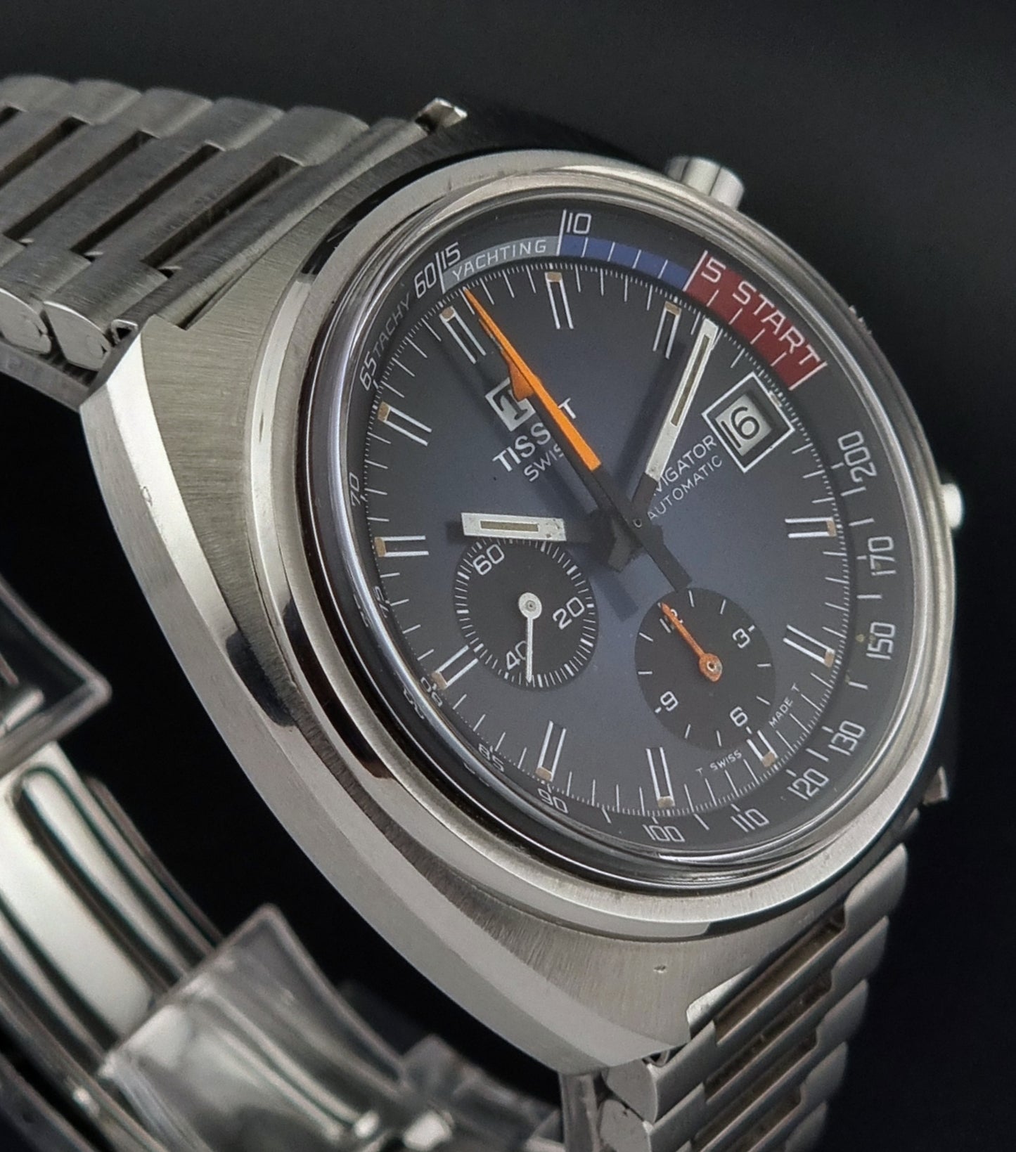 Vintage Tissot wristwatch with a detailed face on a black background