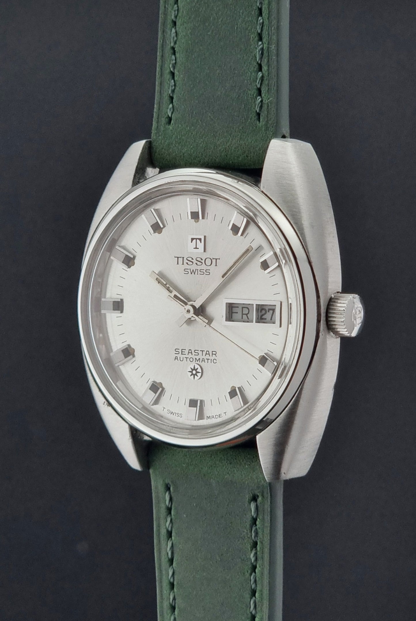 Tissot Seastar 46660 watch with green strap on a dark background