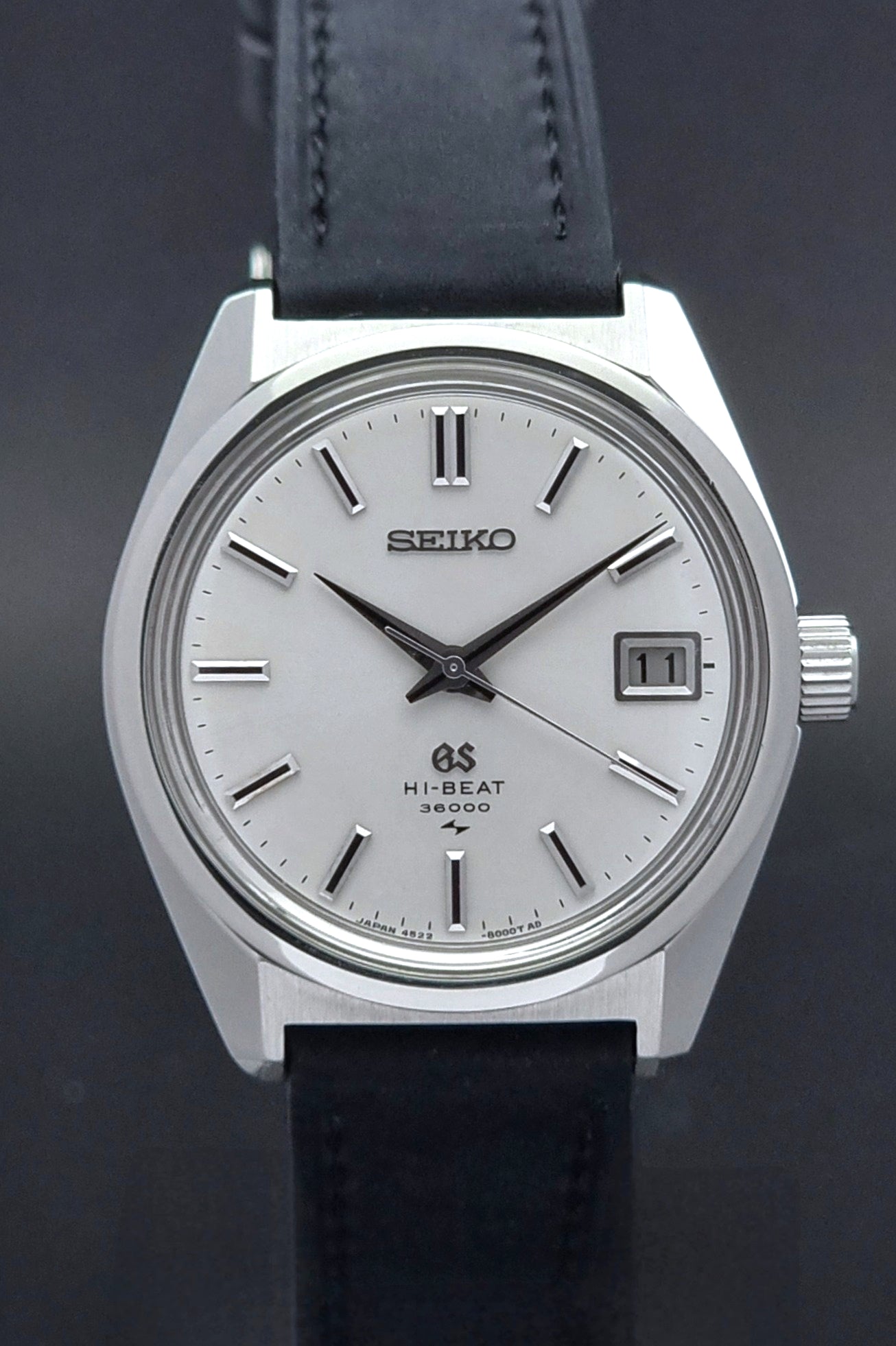 Vintage Grand Seiko 4522-8000 watch with black leather strap on a dark background