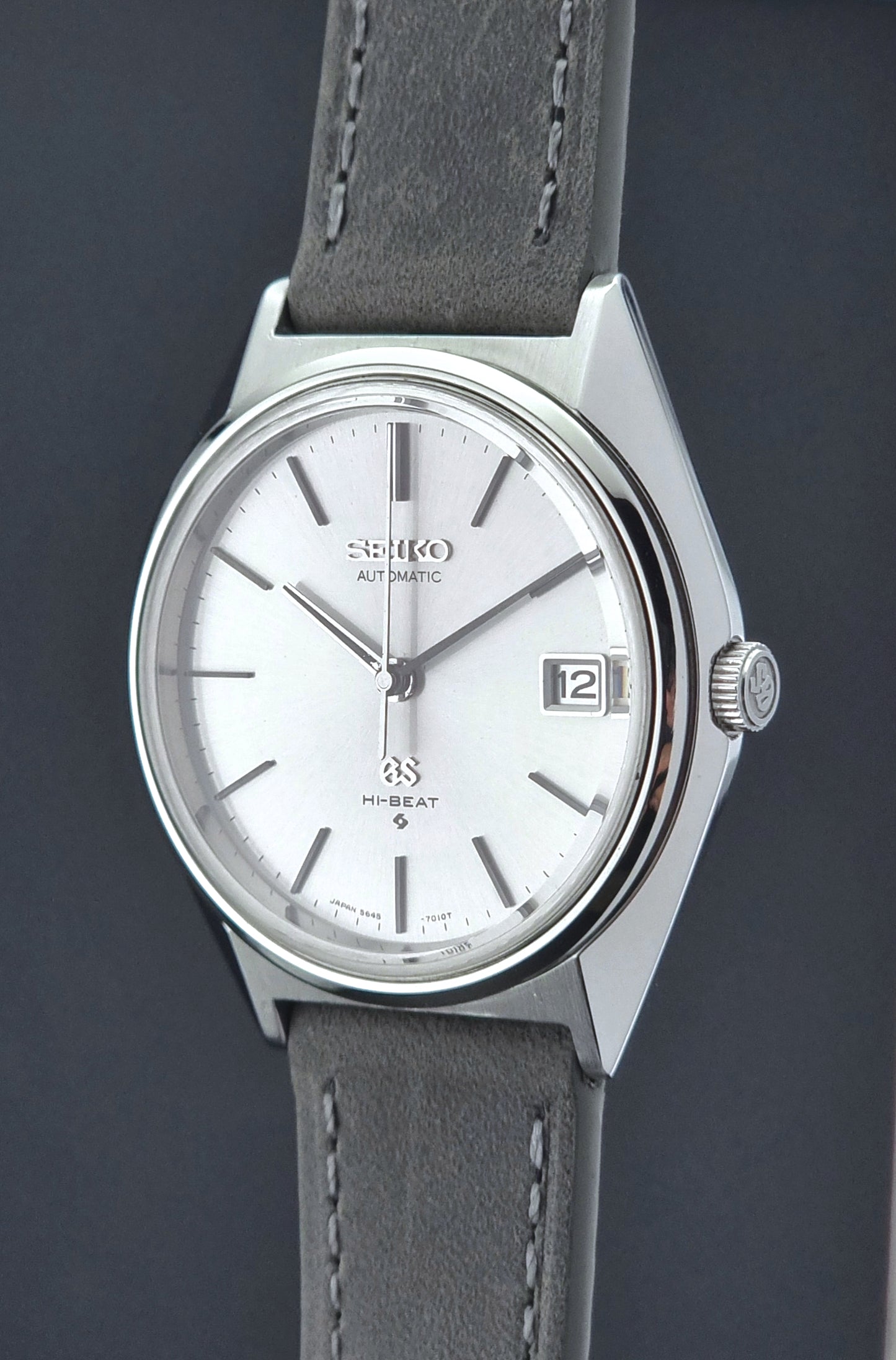 Vintage Grand Seiko watch with gray strap on a dark background