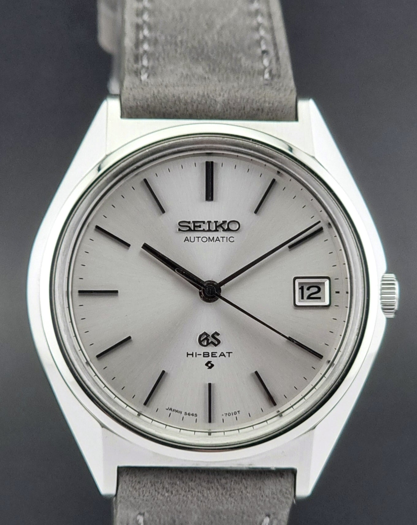 Vintage Grand Seiko watch with gray strap on a dark background