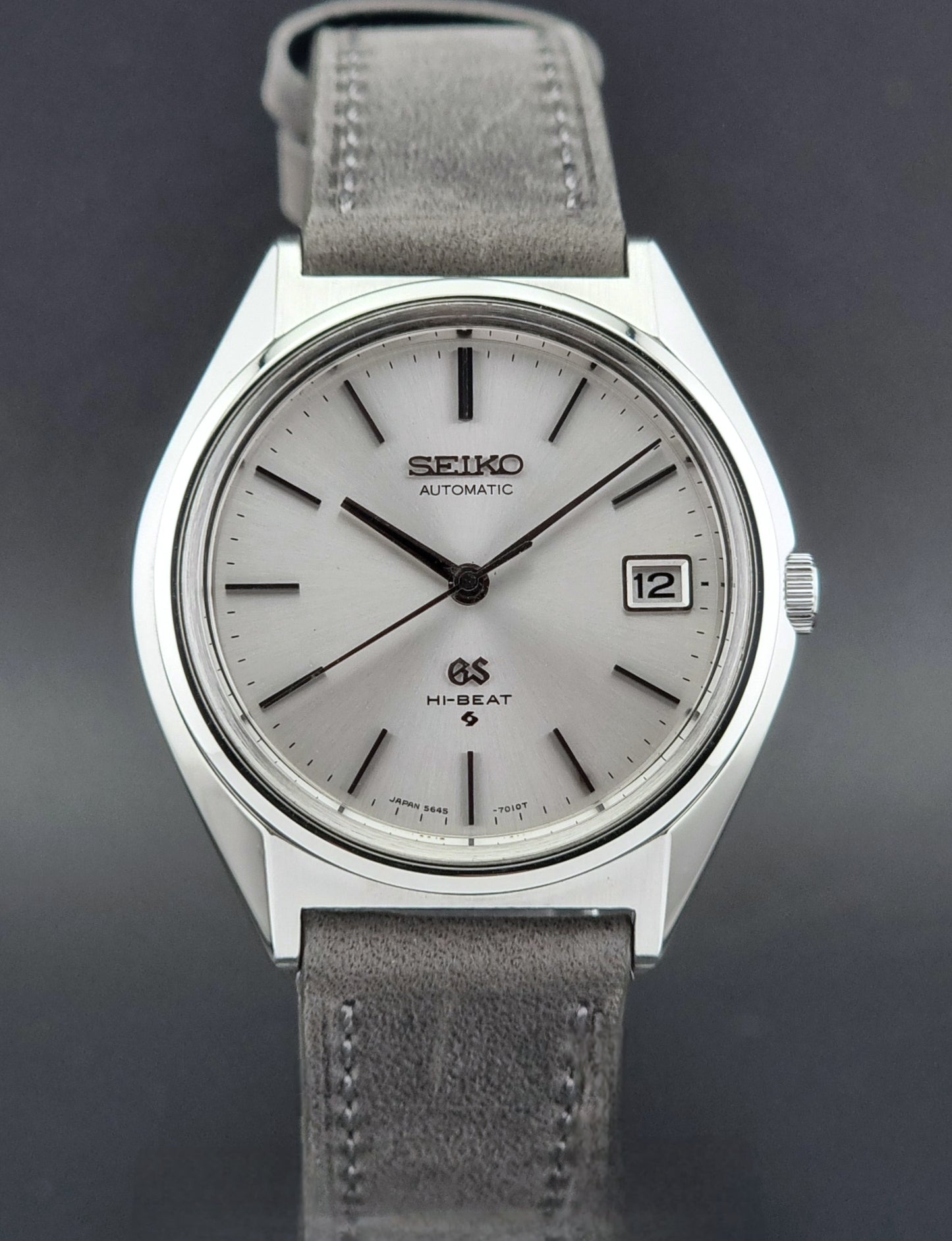 Vintage Grand Seiko watch with gray leather strap on a dark background