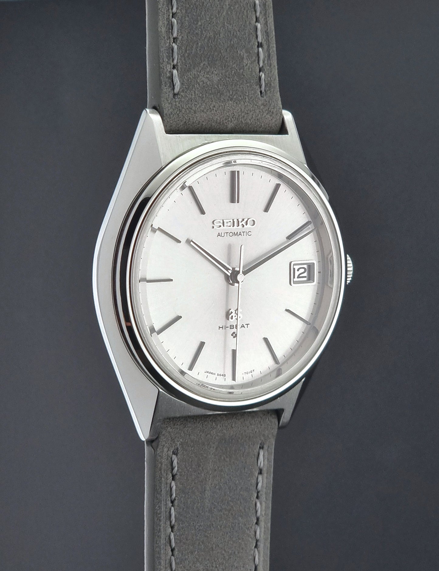 Vintage Grand Seiko watch with gray leather strap on a dark background