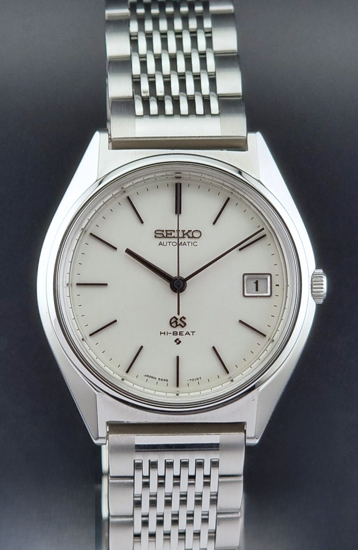 Vintage Grand Seiko Wristwatch 5646-7010 with a white face on a dark background front view
