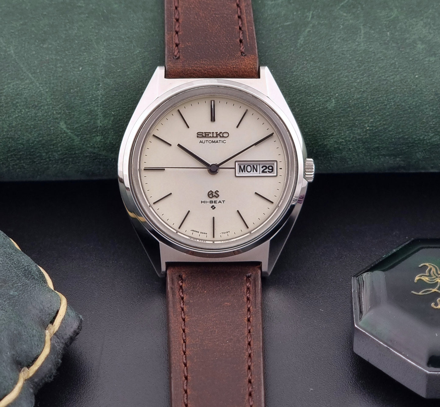 Vintage Grand Seiko Watch with brown leather strap on a dark surface
