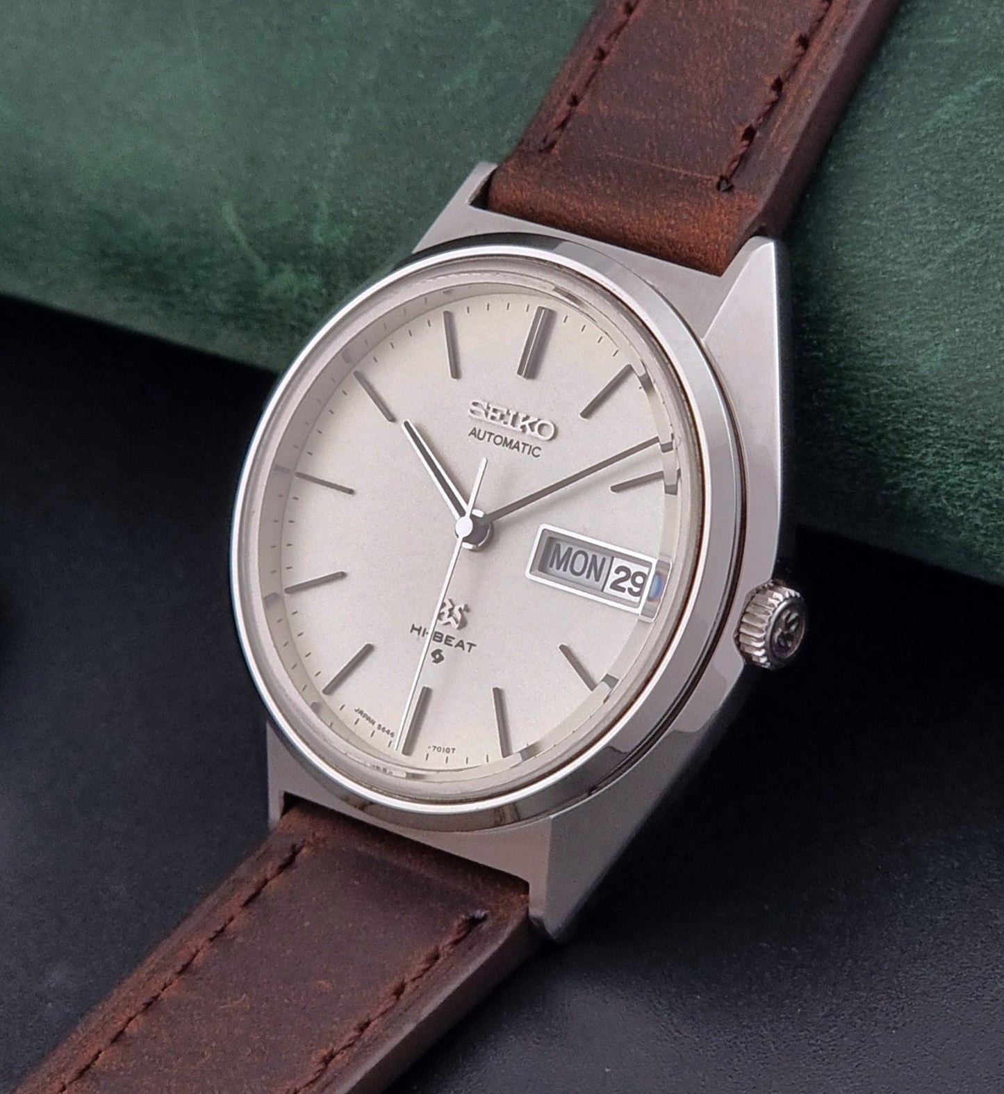 Vintage Grand Seiko Watch with brown leather strap on a dark surface