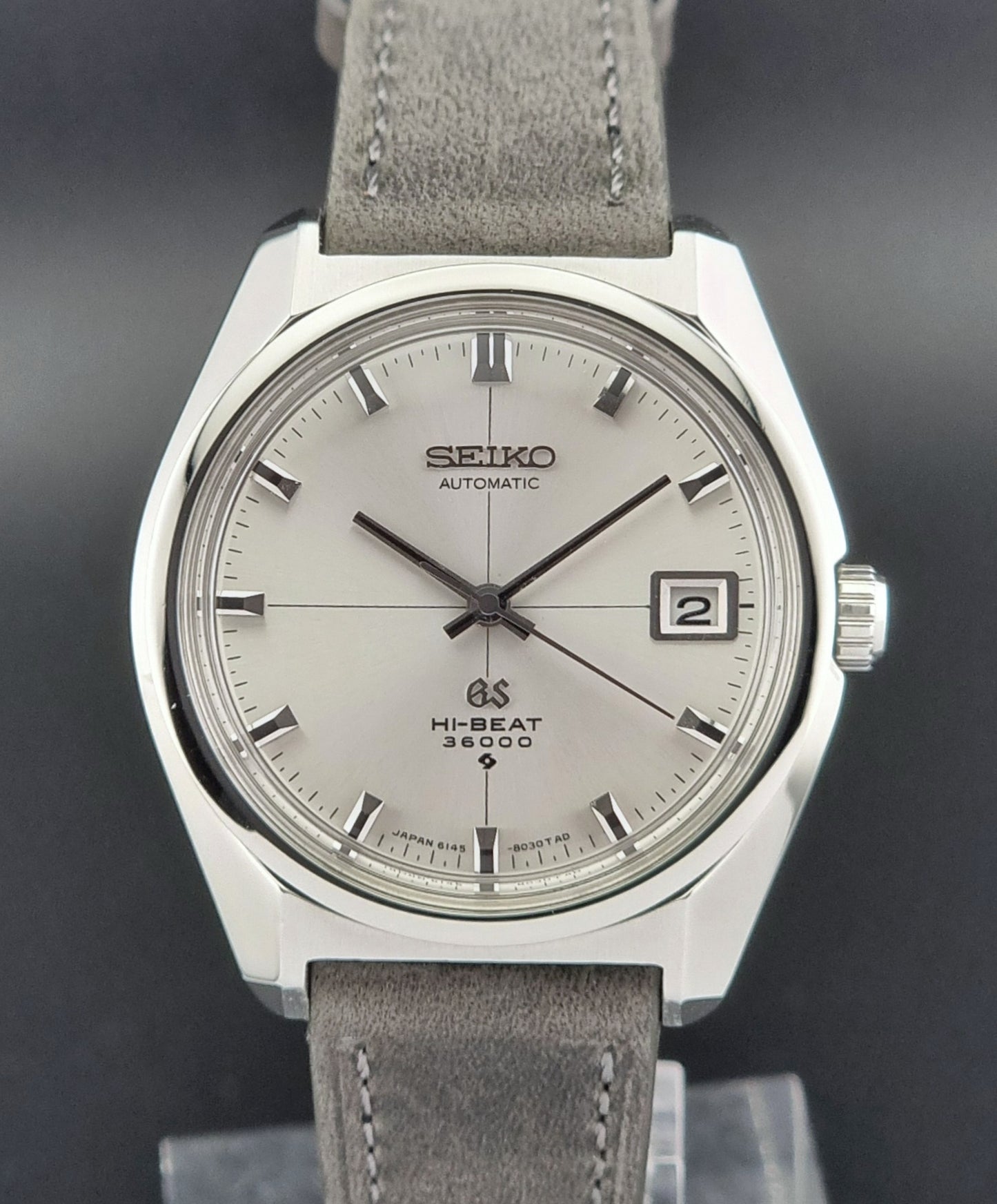 Vintage Grand Seiko watch with gray strap on a dark background