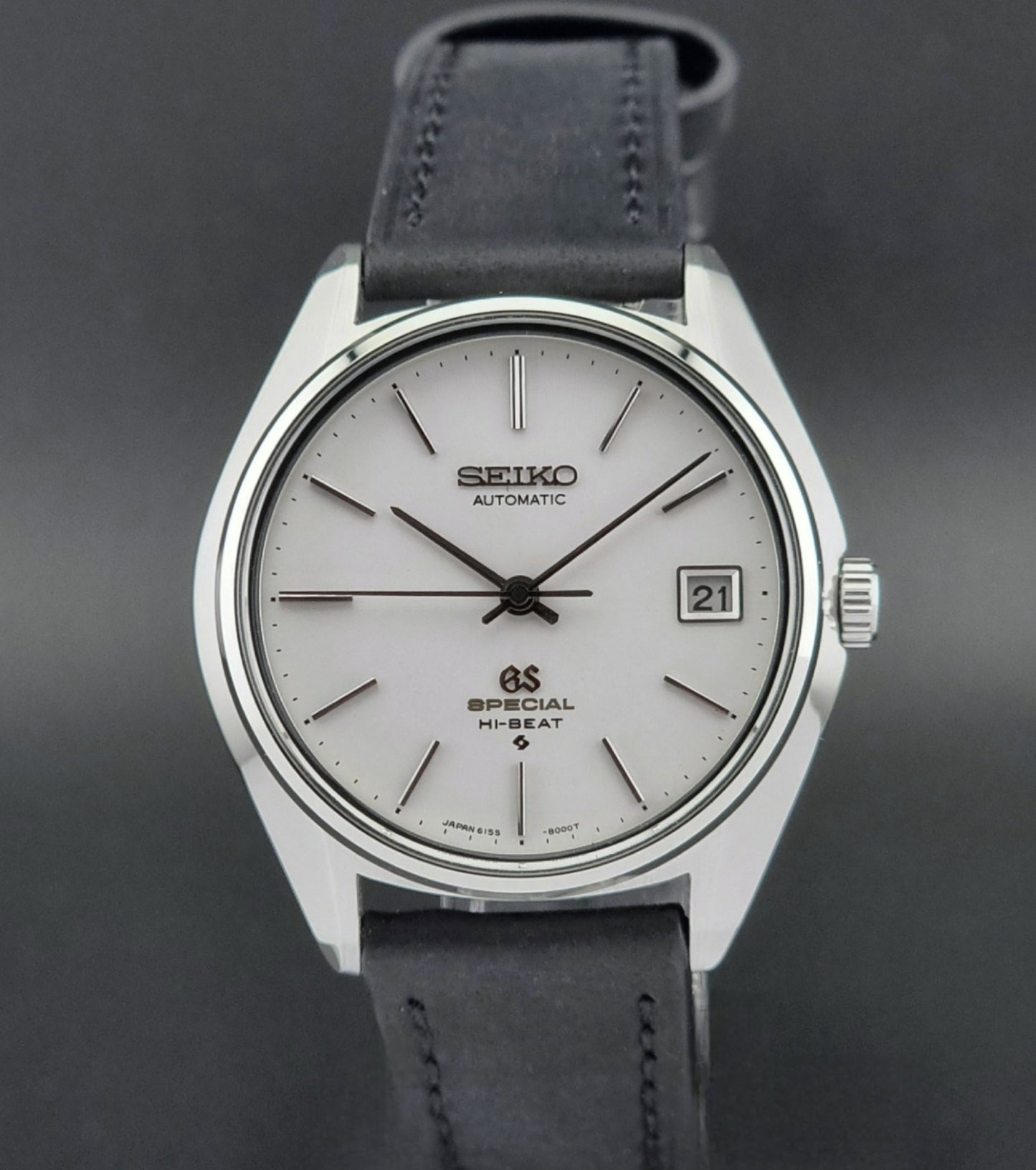 Vintage Grand Seiko Wristwatch with black leather strap on a dark background