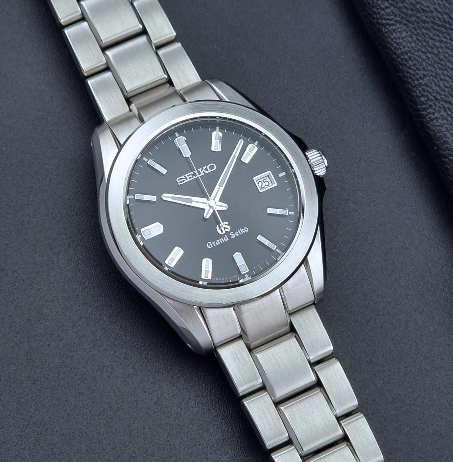 Grand Seiko quartz watch 8J56-8020 with a dark face on a dark background front view