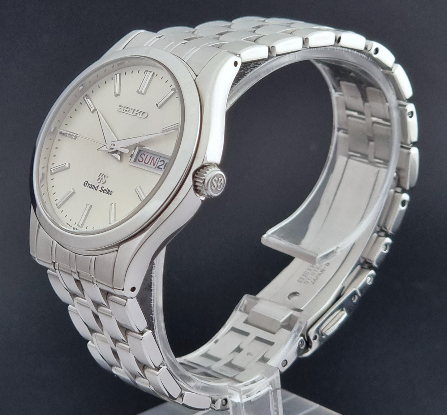 Vintage Grand Seiko SBGT005 quartz watch 9F83-9A30 with bracelet on a dark background full view crown side