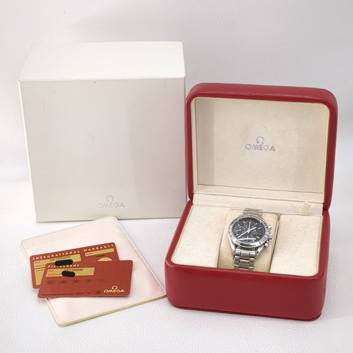 Speedmaster watch in a red Omega box with a white background