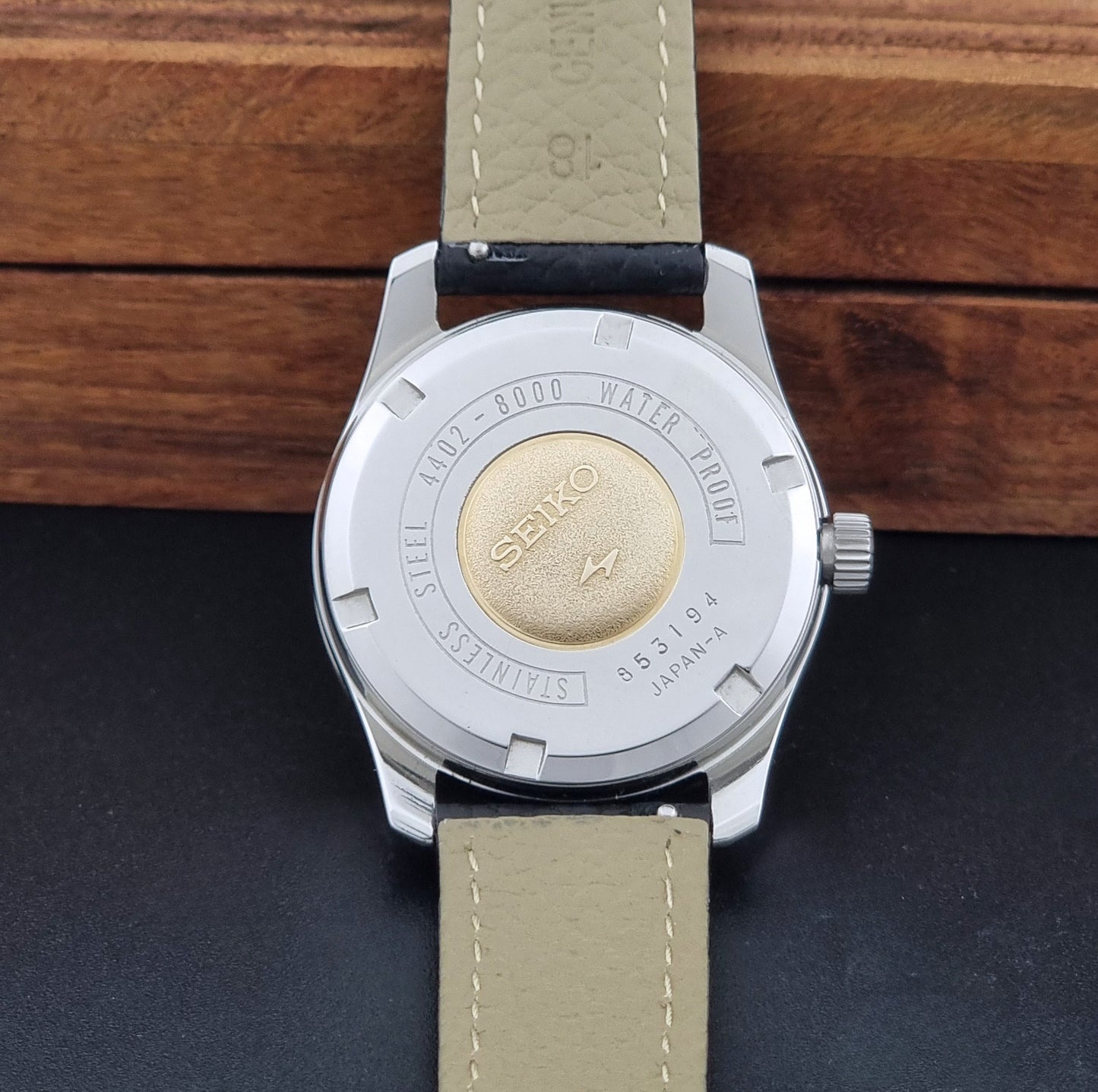 Vintage King Seiko 4402-8000 Wristwatch with a white dial on a dark background case back view