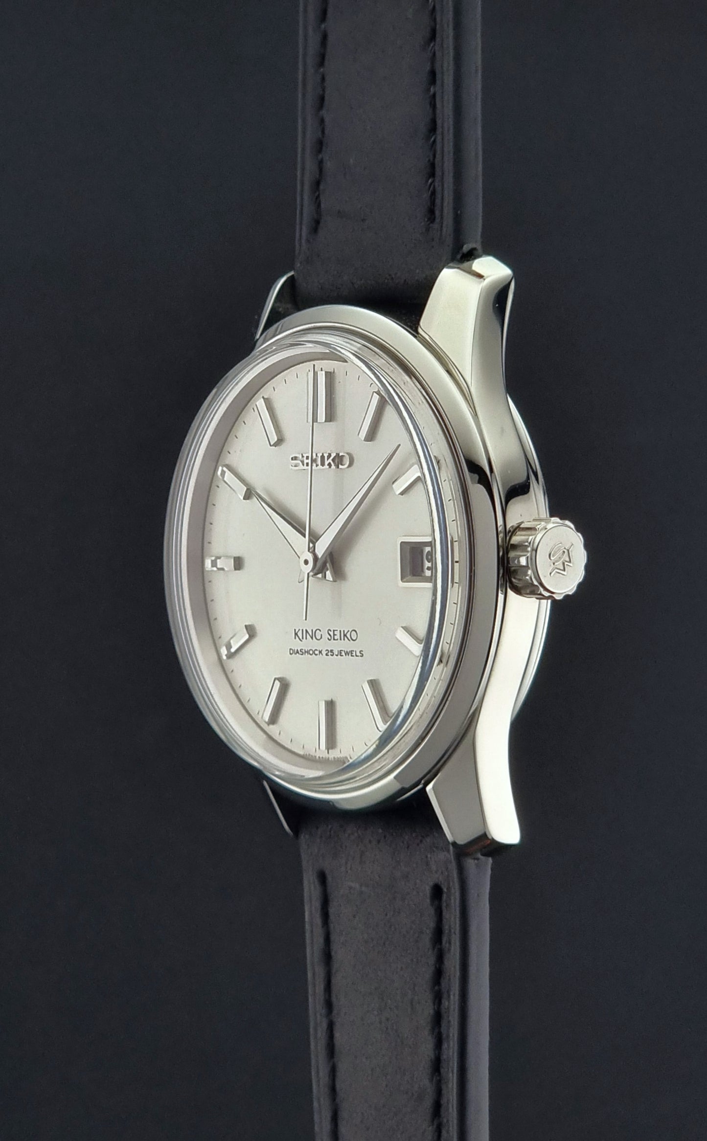 Vintage King Seiko 4402-8000 Wristwatch with silver case and black leather strap on a dark background