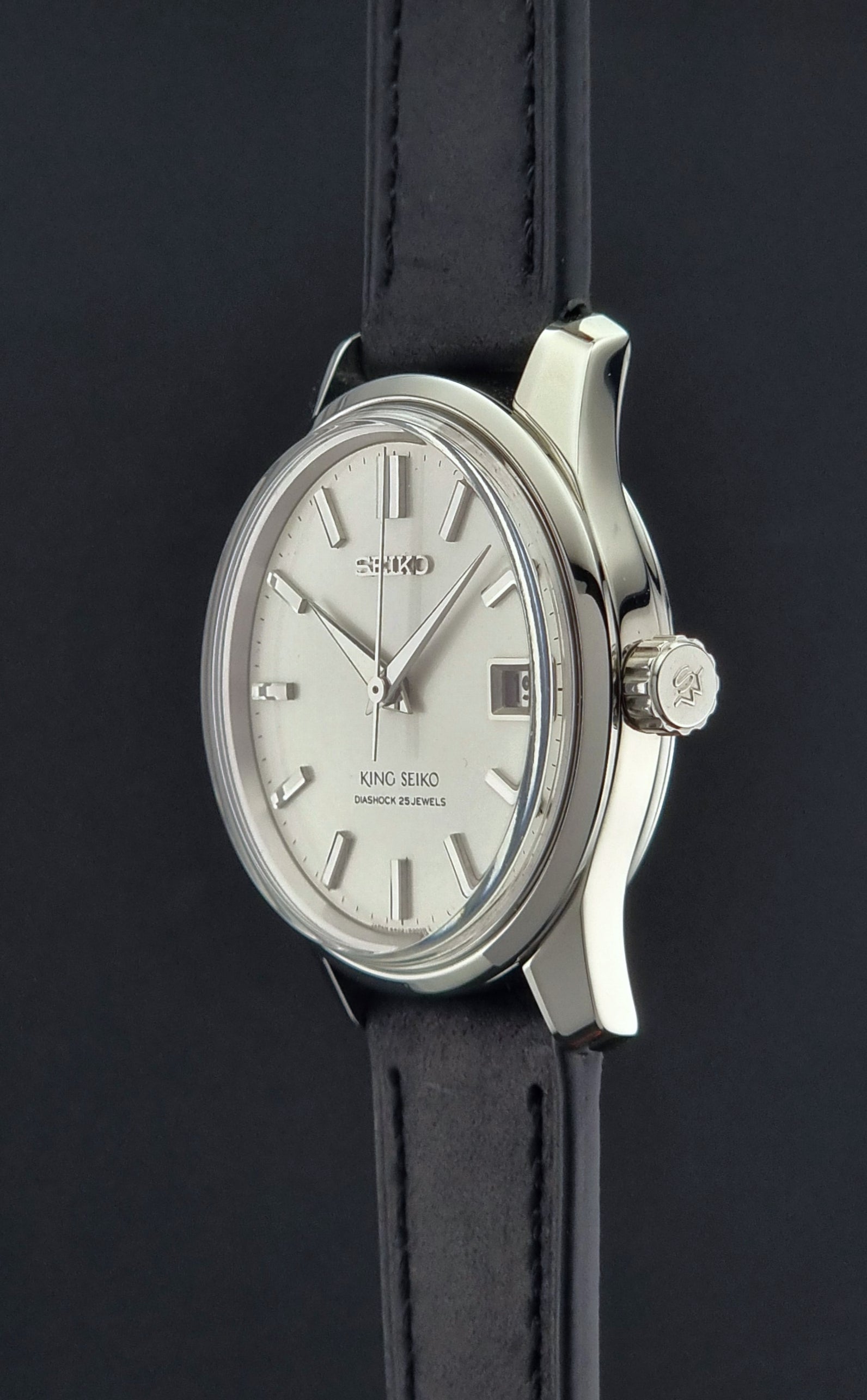 Vintage King Seiko 4402-8000 Wristwatch with silver case and black leather strap on a dark background