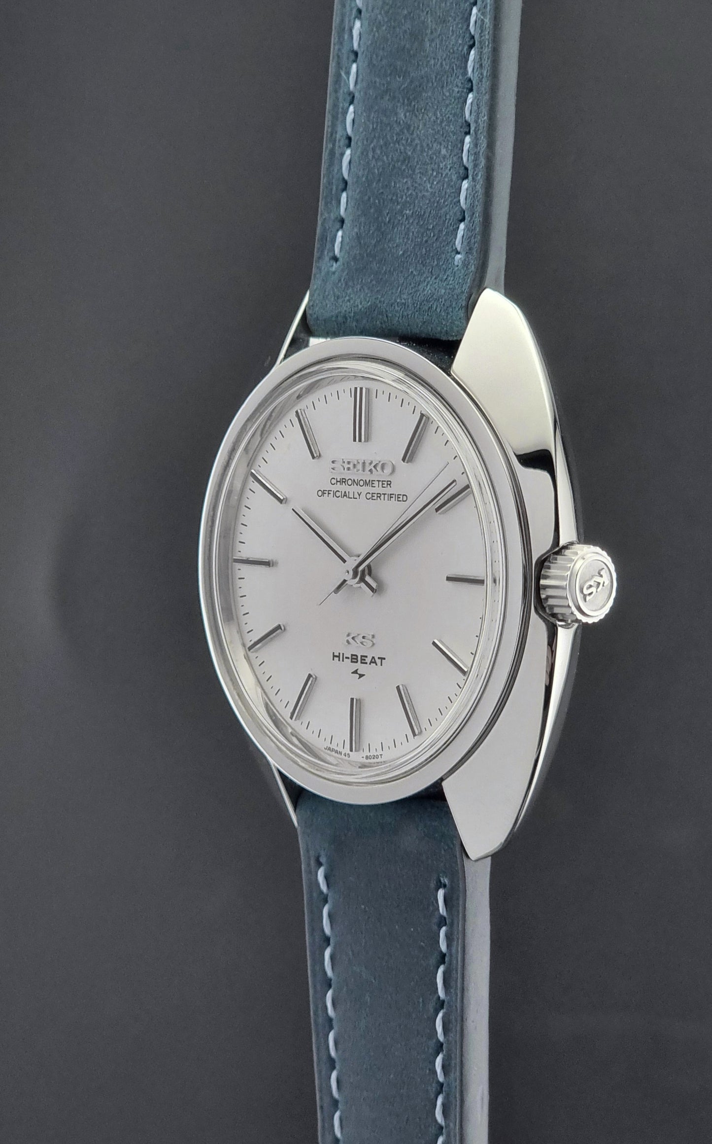Vintage King Seiko Wristwatch with blue leather strap and silver case on a dark background
