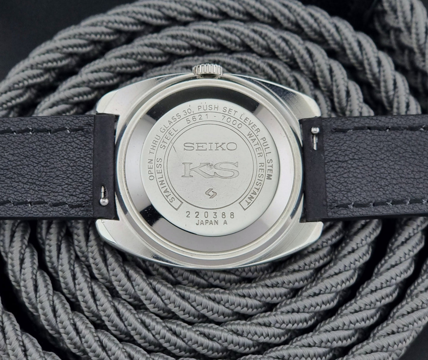 Vintage King Seiko 5621-700 Wristwatch with black leather strap on a dark surface case back