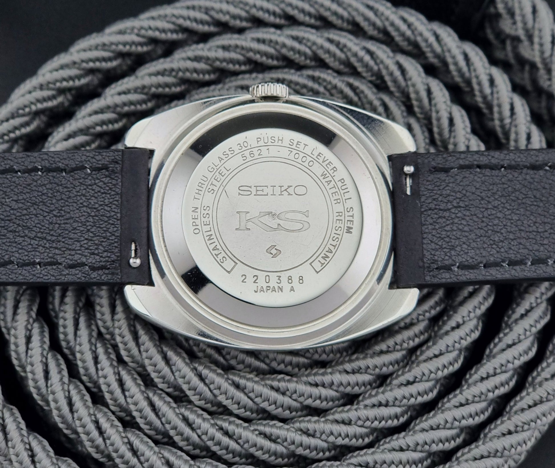 Vintage King Seiko 5621-700 Wristwatch with black leather strap on a dark surface case back