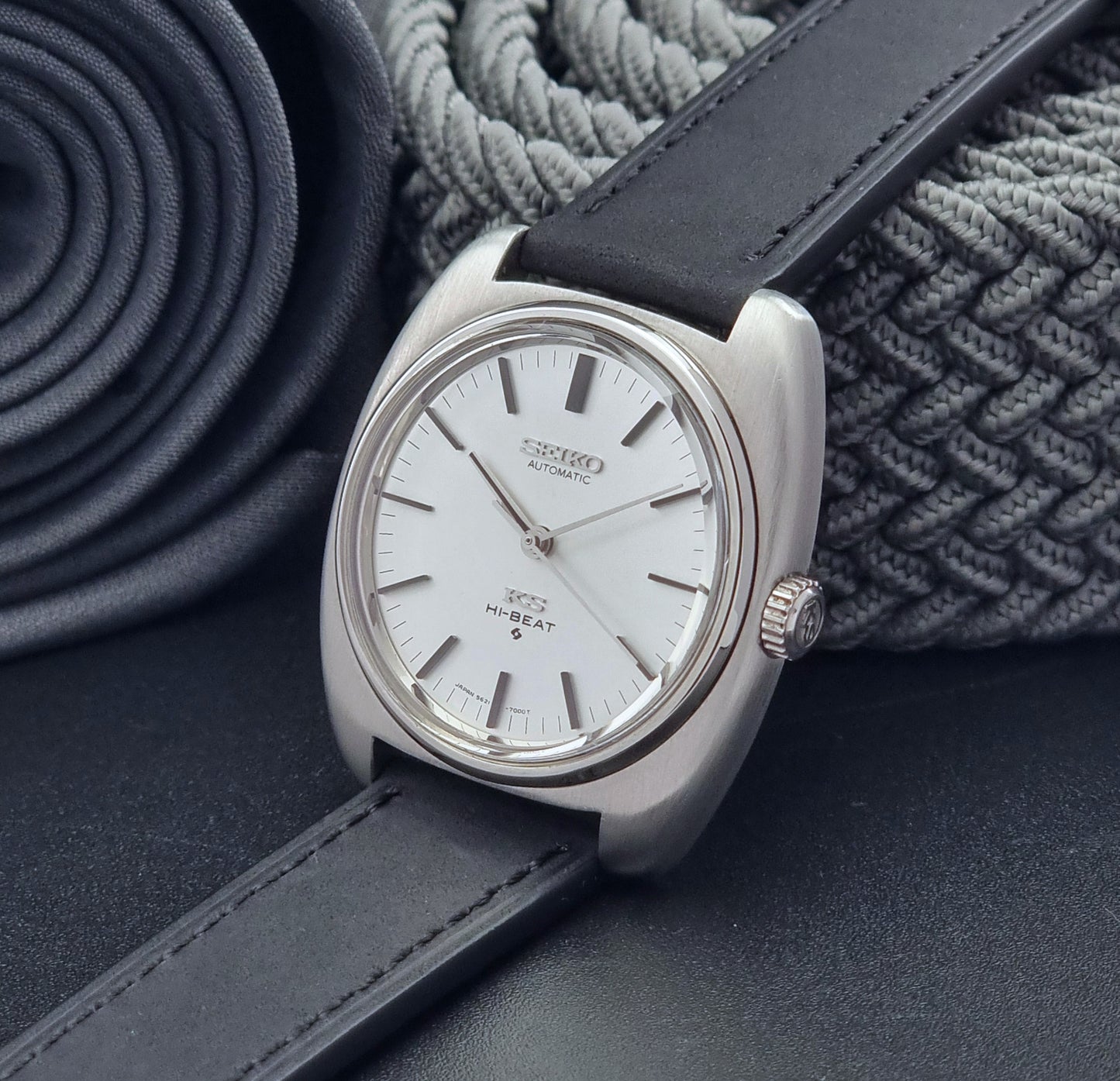 Vintage King Seiko 5621-700 Wristwatch with black leather strap on a dark surface crown view