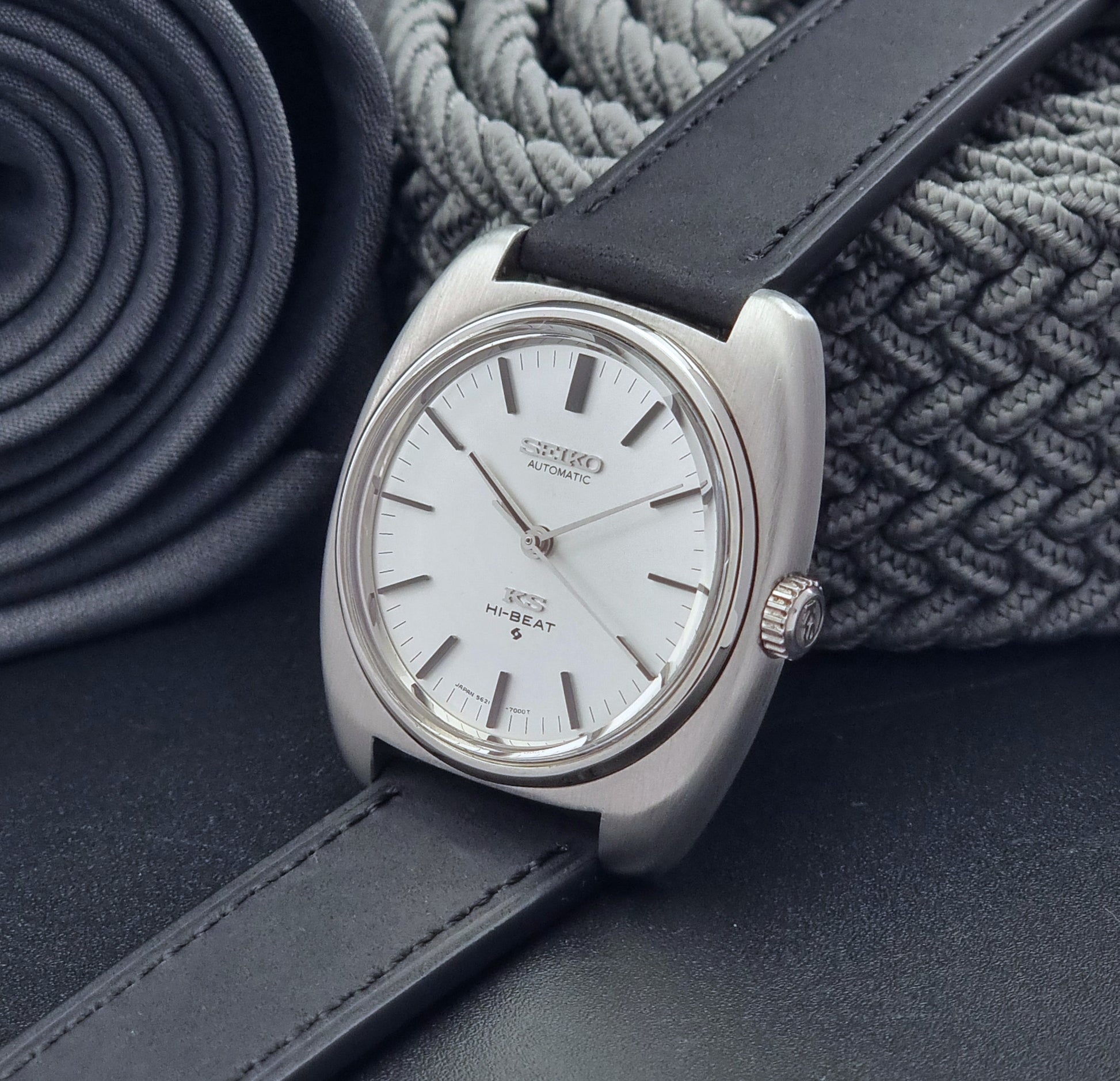 Vintage King Seiko 5621-700 Wristwatch with black leather strap on a dark surface crown view