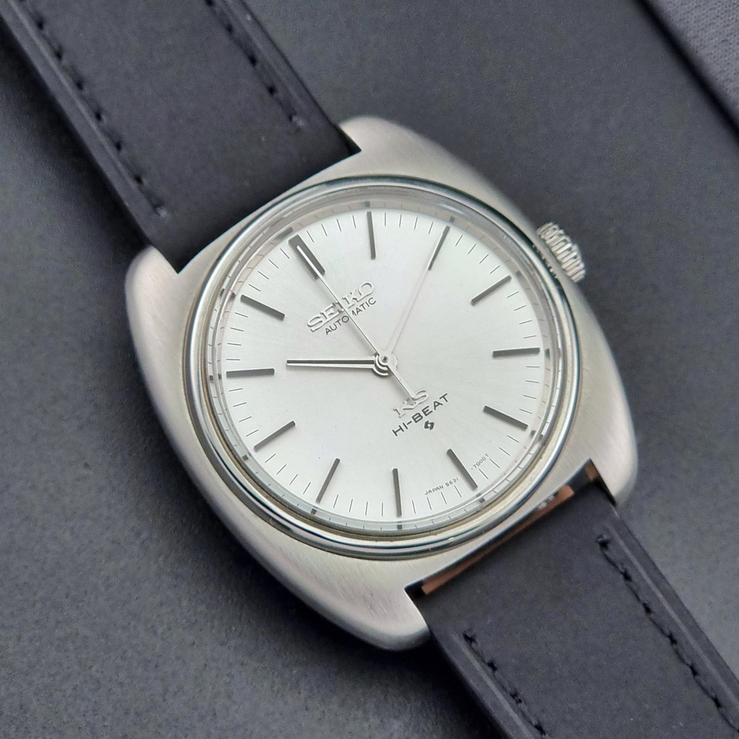 Vintage King Seiko 5621-700 Wristwatch with black leather strap on a dark surface close up dial