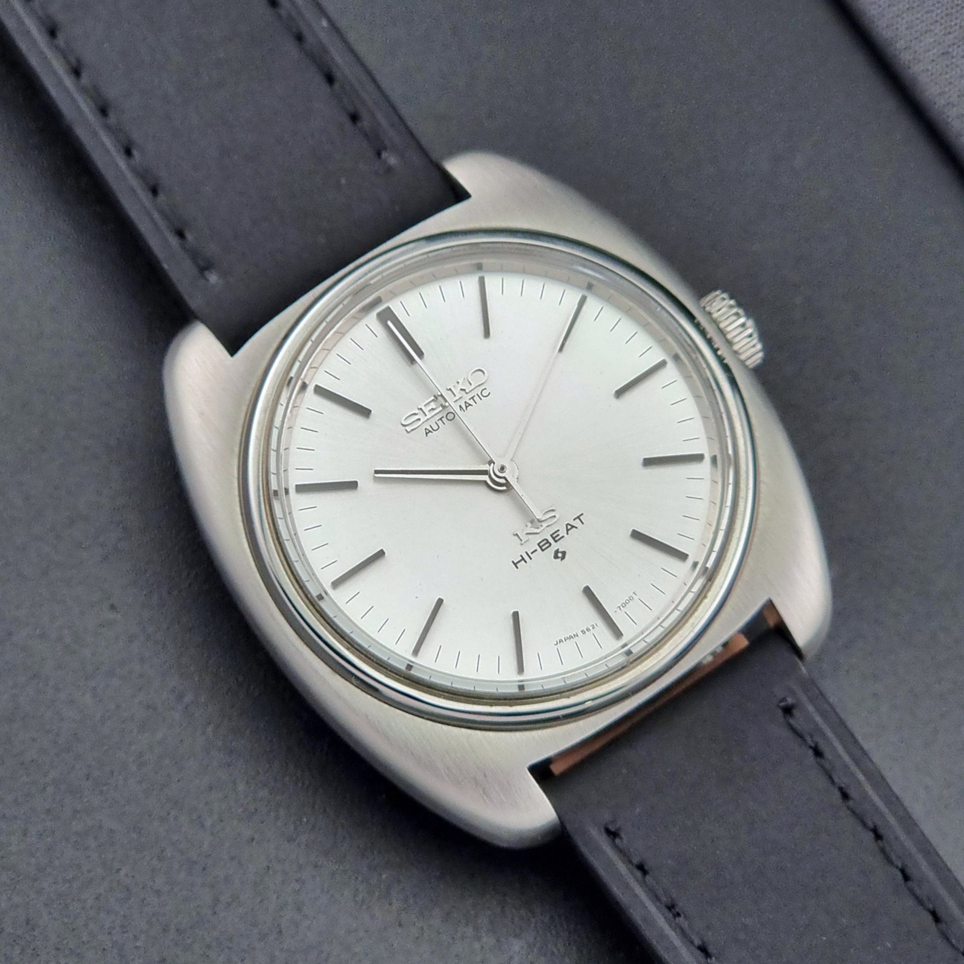 Vintage King Seiko 5621-700 Wristwatch with black leather strap on a dark surface close up dial