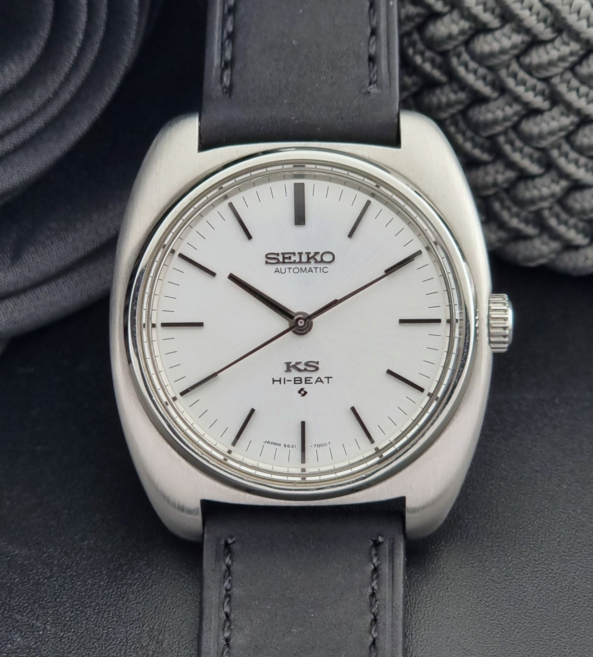 Vintage King Seiko 5621-700 Wristwatch with black leather strap on a dark surface close up dial view