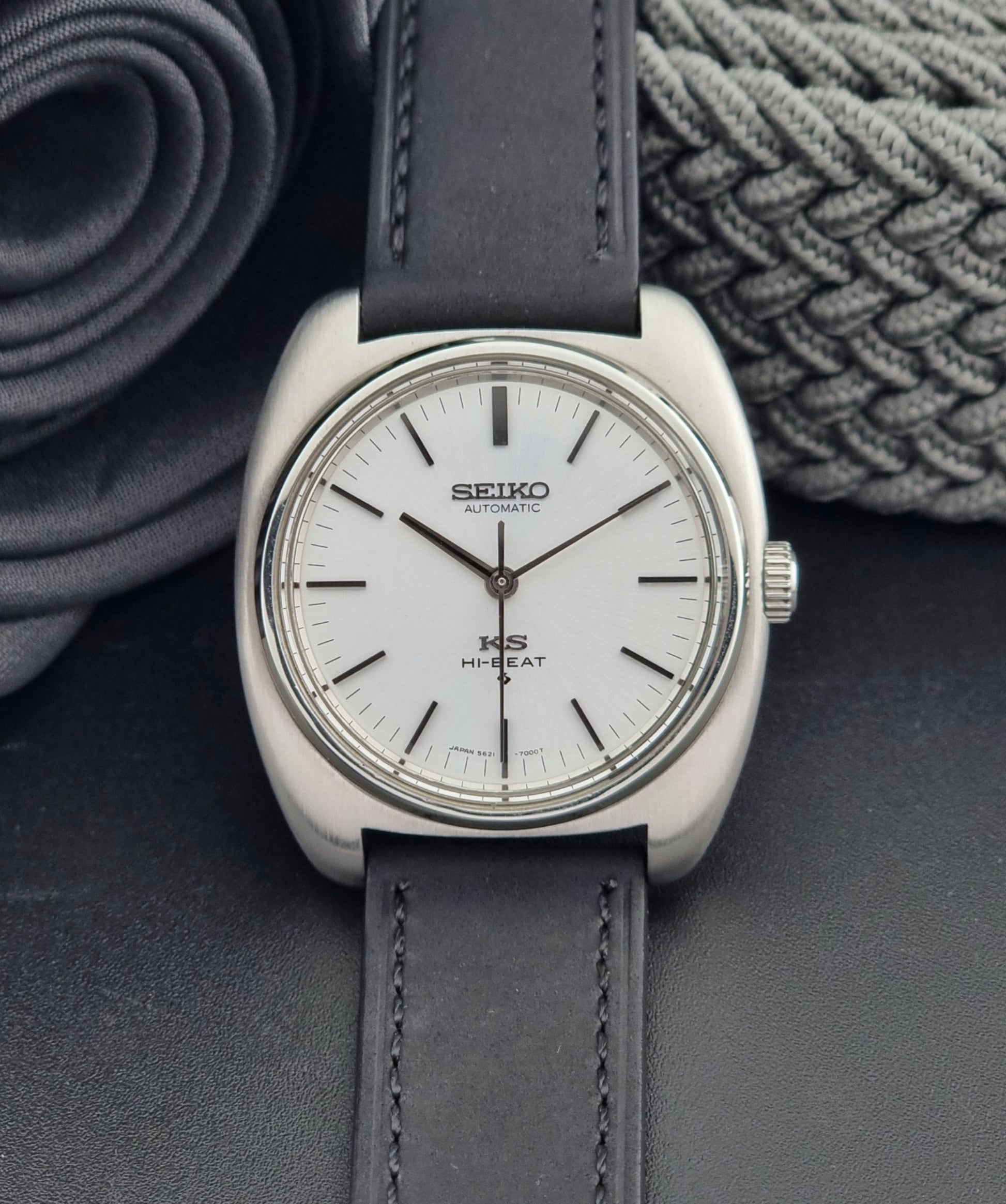 Vintage King Seiko 5621-700 Wristwatch with black leather strap on a dark surface front view