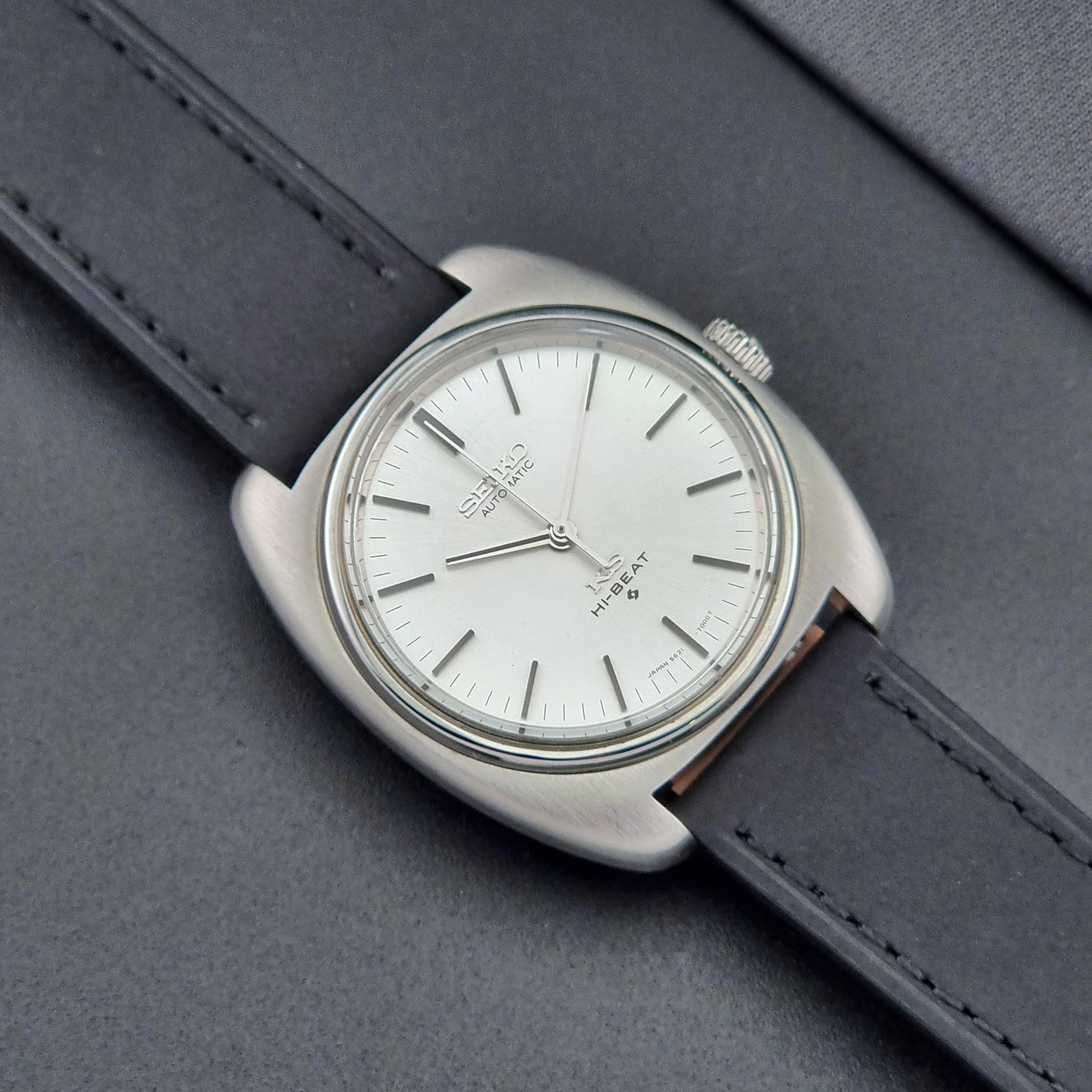 Vintage King Seiko 5621-700 Wristwatch with black leather strap on a dark surface