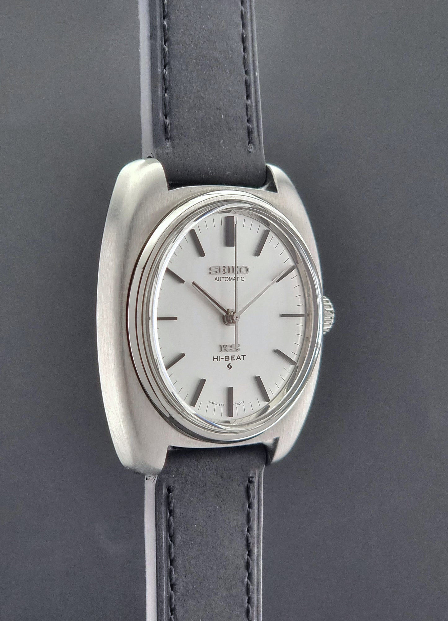 Vintage King Seiko 5621-700 Wristwatch with black leather strap on a dark surface side profile