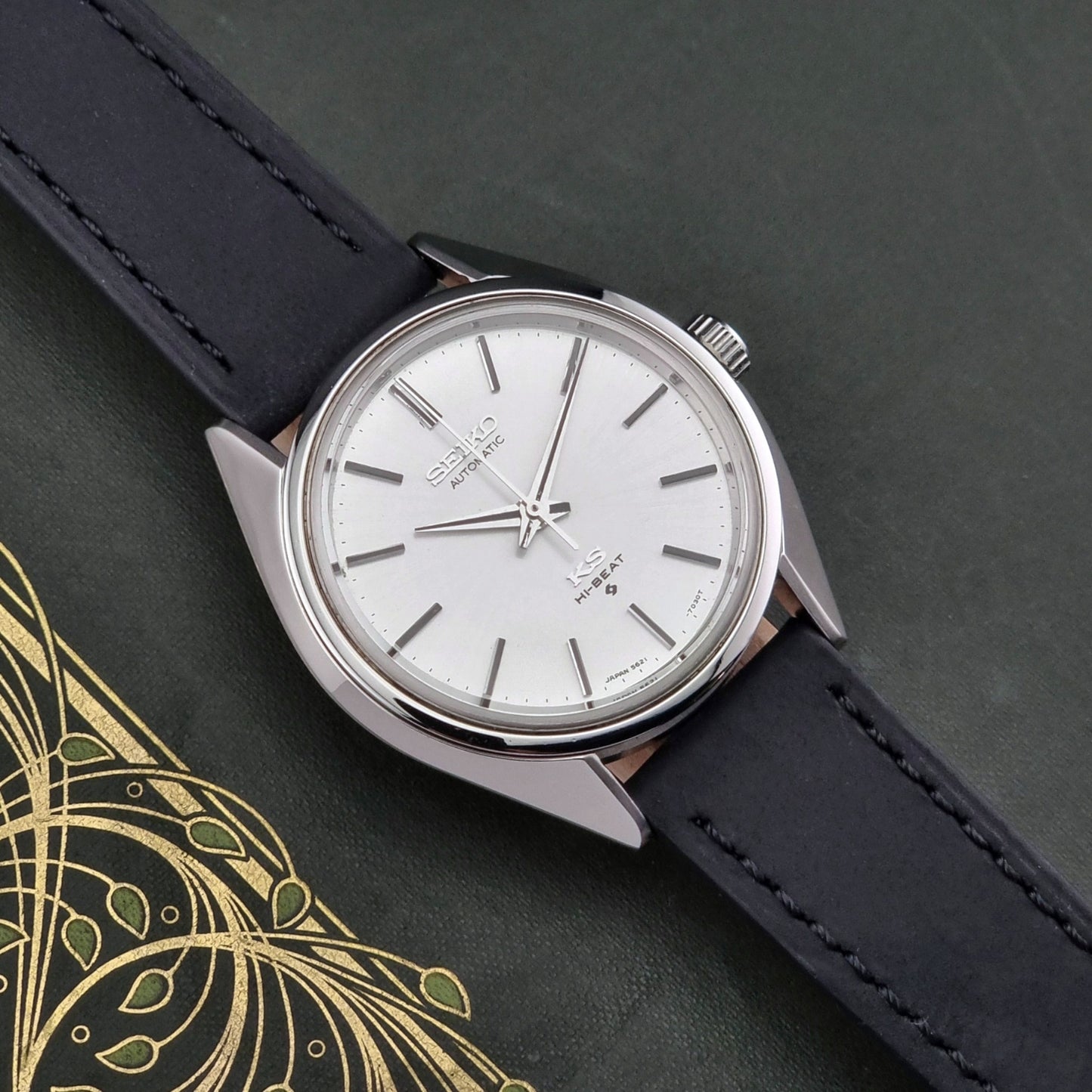 King Seiko watch with black leather strap on a dark background