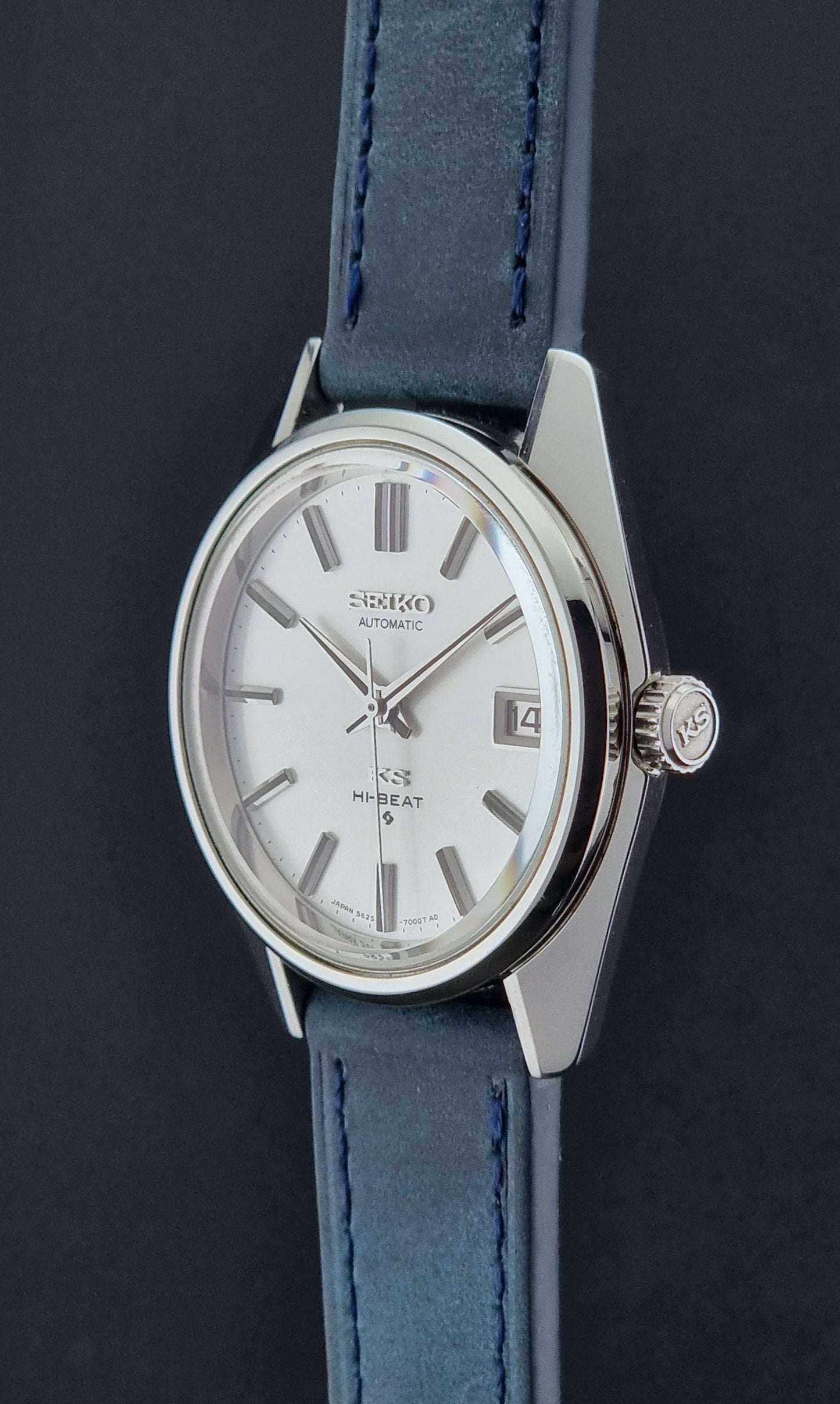 Vintage King Seiko 5625-7000 Wristwatch with blue strap and silver case on a dark textured background