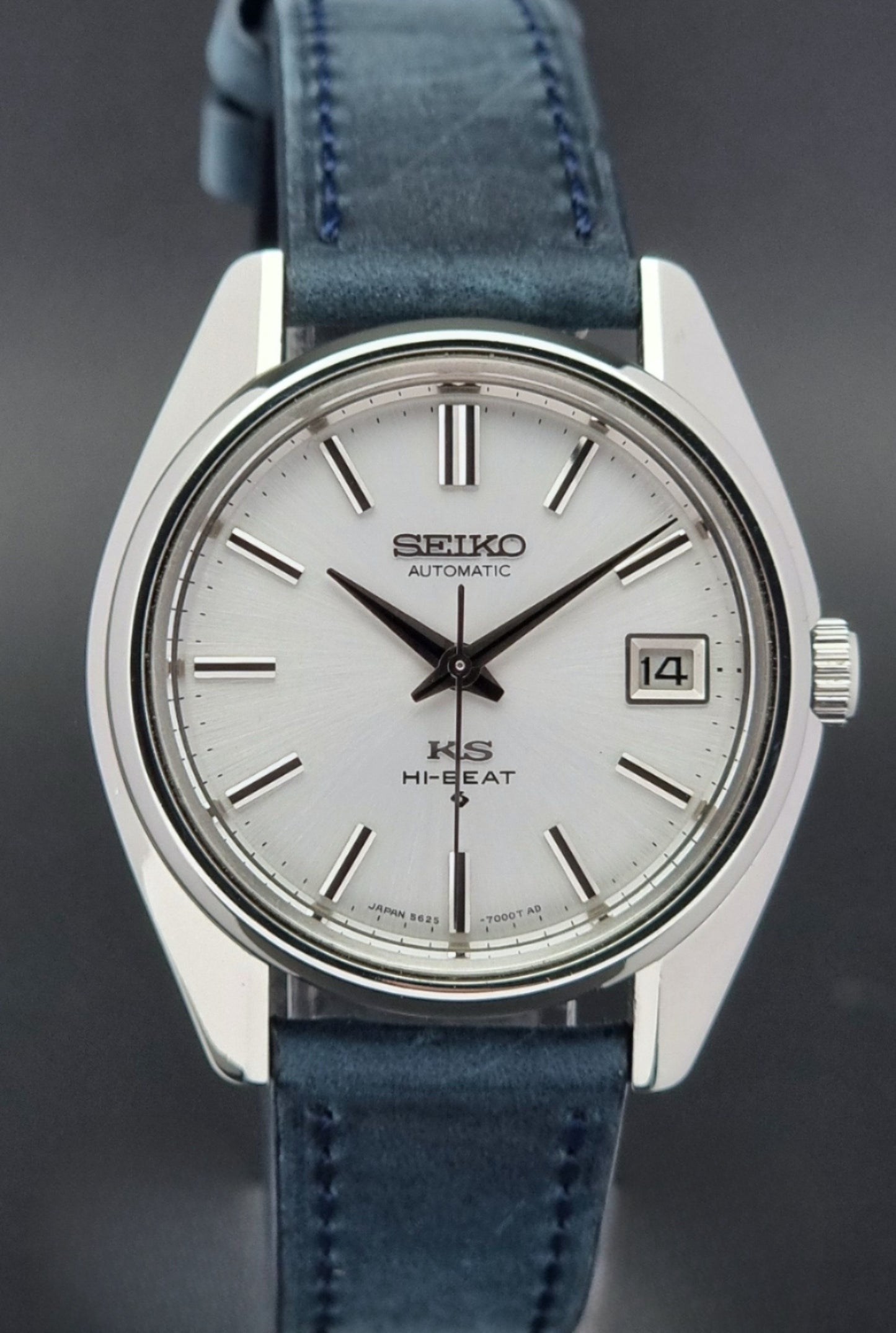 Vintage King Seiko 5625-7000 Wristwatch with blue strap and silver case on a dark textured background