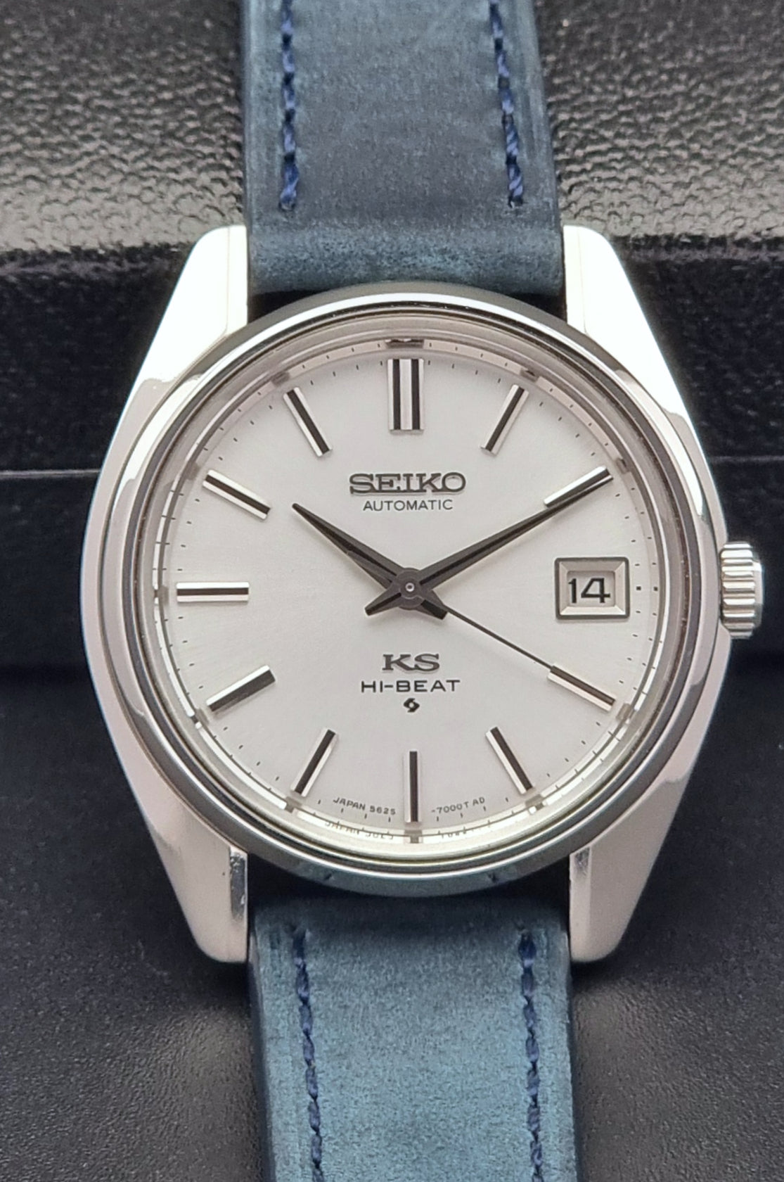 Vintage King Seiko 5625-7000 Wristwatch with blue strap and silver case on a dark textured background