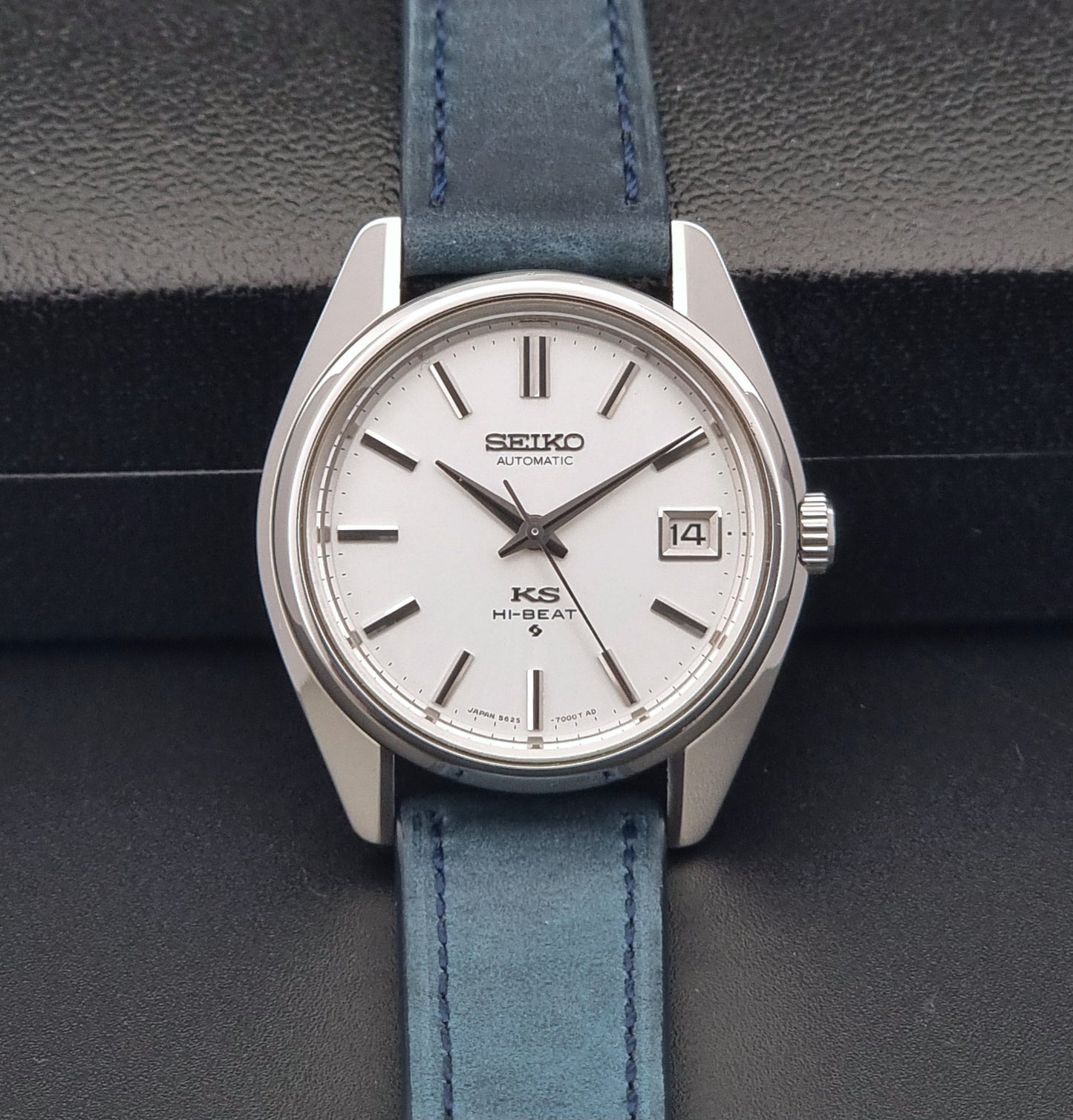 Vintage King Seiko 5625-7000 Wristwatch with blue strap and silver case on a dark textured background